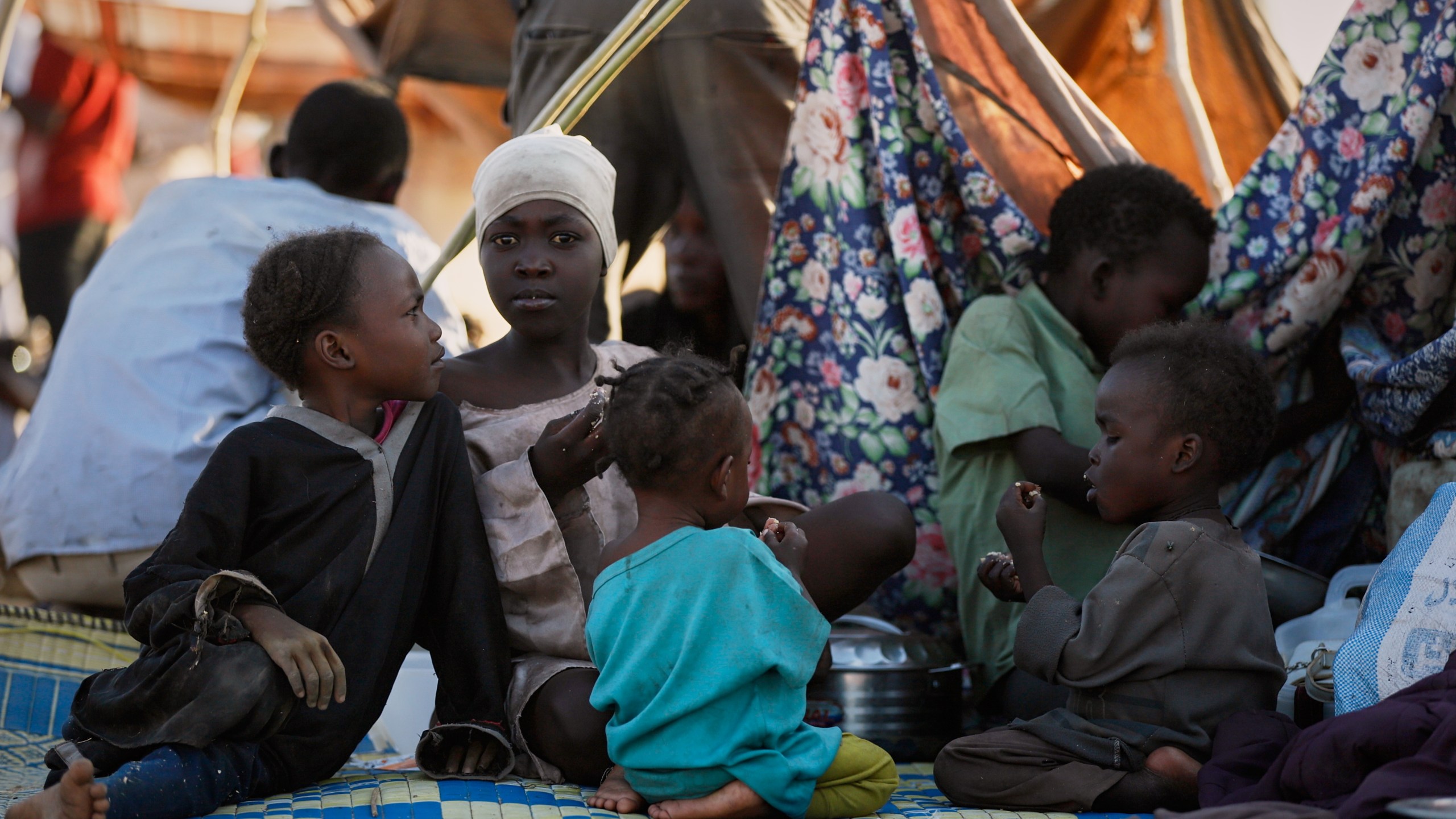 This photo released by UNICEF shows displaced children and families from el-Fasher at a displacement camp where they sought refuge from fighting between government forces and the RSF, in Tawila, Darfur region, Sudan, Monday, Oct. 27, 2025. (MohammedJammal/UNICEF via AP)