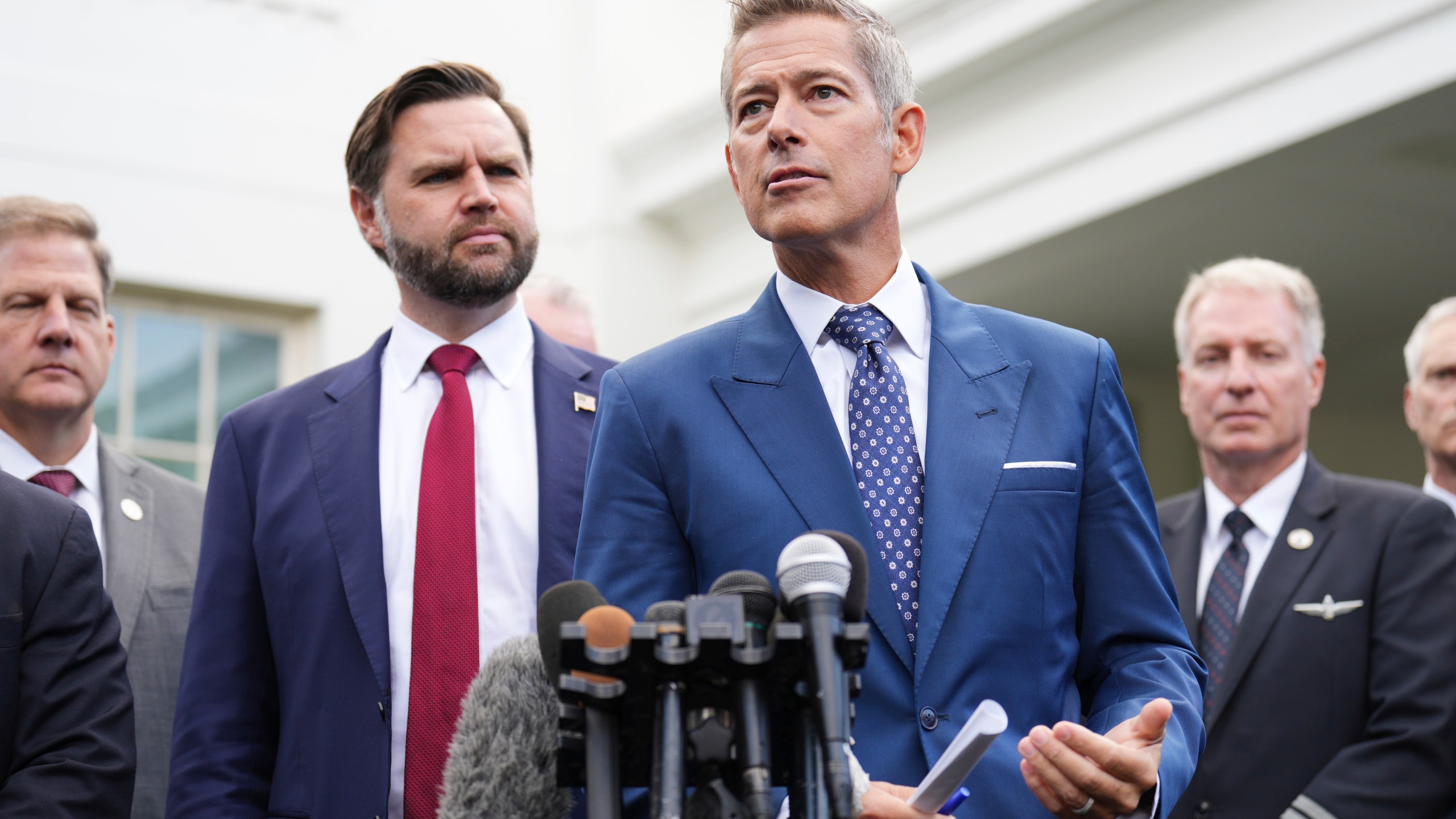 Transportation Secretary Sean Duffy, from right, speaks alongside Vice President JD Vance and Chris Sununu, president & CEO of Airlines for America, about the impact of the government shutdown on the aviation industry, outside of the West Wing of the White House, Thursday, Oct. 30, 2025, in Washington. (AP Photo/Jacquelyn Martin)