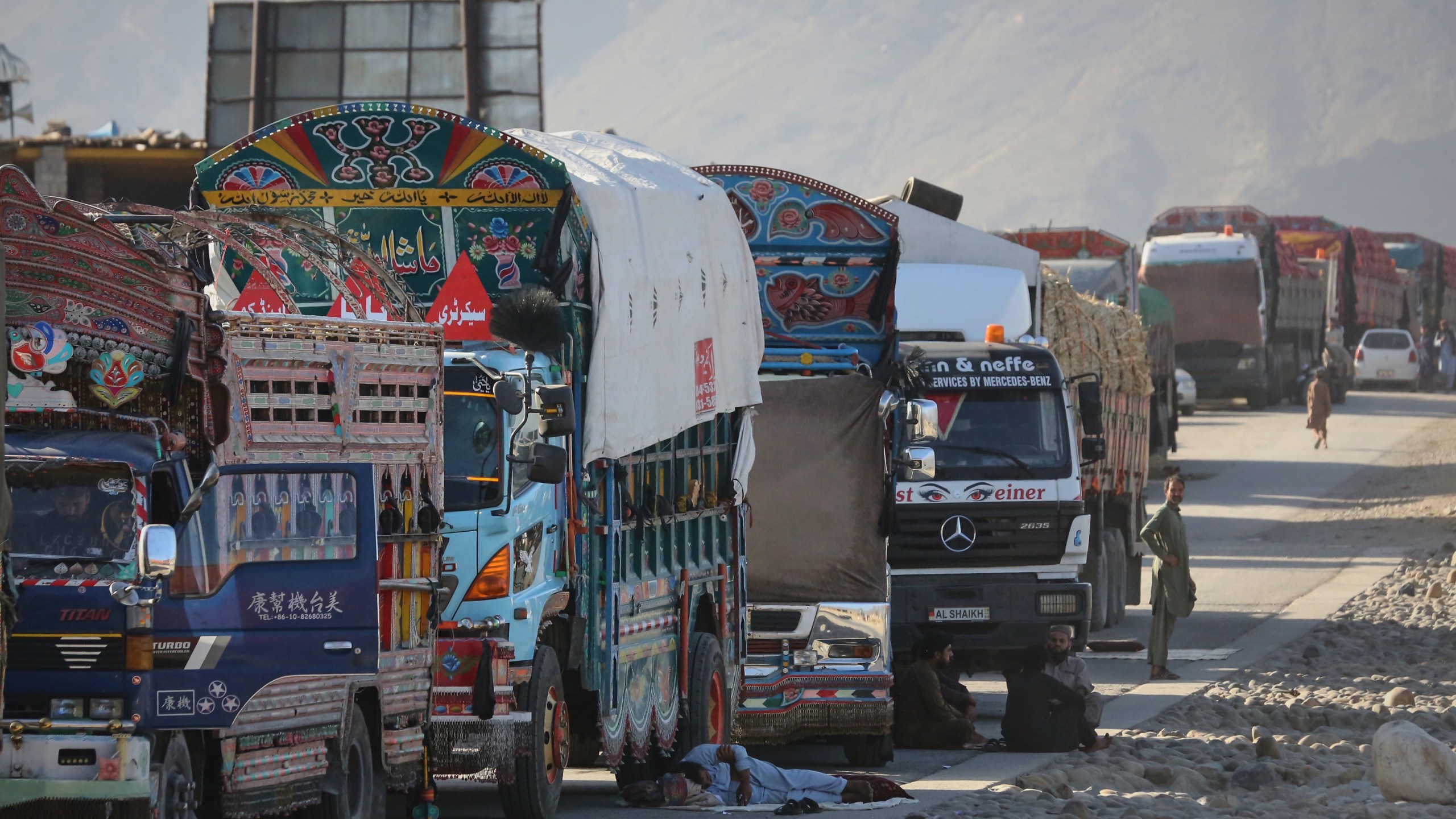 A line of cargo trucks bound for Pakistan is stranded on the Afghan side of the Torkham border crossing, which remained closed after clashes, in Nangarhar province, Afghanistan, Tuesday, Oct. 14, 2025. (AP Photo/Wahidullah Kakar)