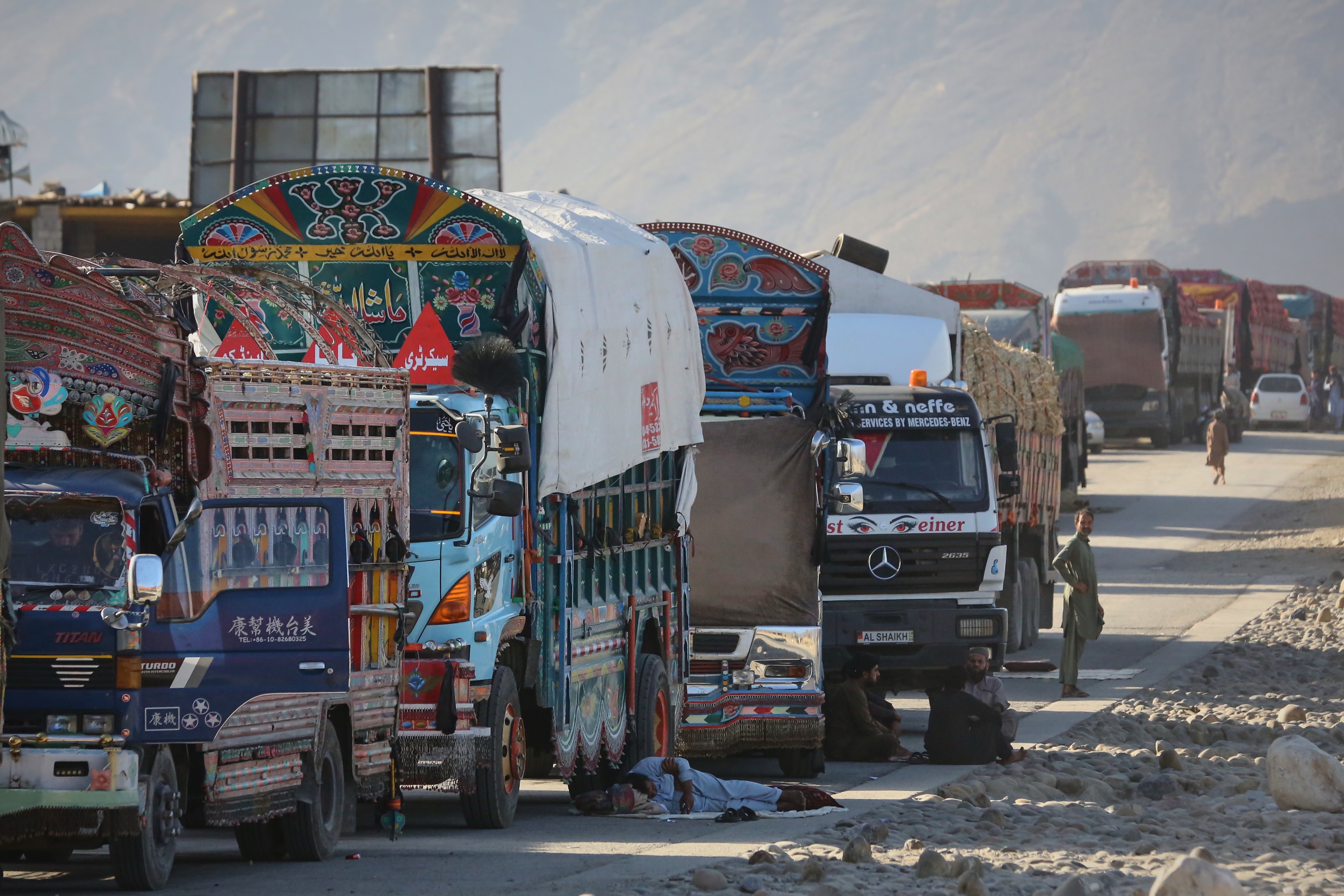 A line of cargo trucks bound for Pakistan is stranded on the Afghan side of the Torkham border crossing, which remained closed after clashes, in Nangarhar province, Afghanistan, Tuesday, Oct. 14, 2025. (AP Photo/Wahidullah Kakar)