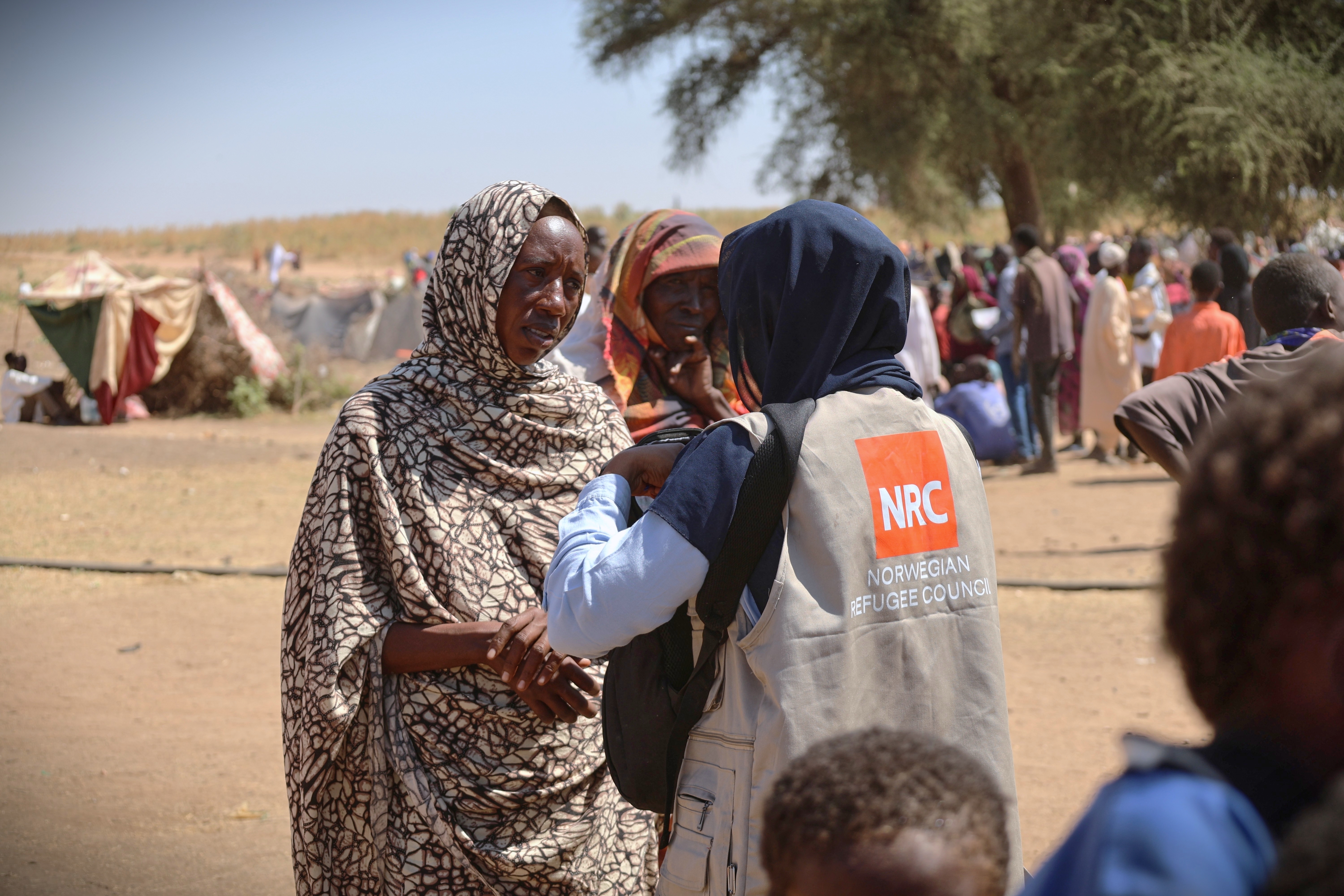 CORRECTS BYLINE.-This photo released by The Norwegian Refugee Council (NRC), shows a woman talking with an aid worker at a displacement camp where residents from el-Fasher sought refuge from fighting between government forces and the RSF, in Tawila, Darfur region, Sudan, Monday, Nov. 3, 2025. (Sarah Vuylsteke/NRC via AP)