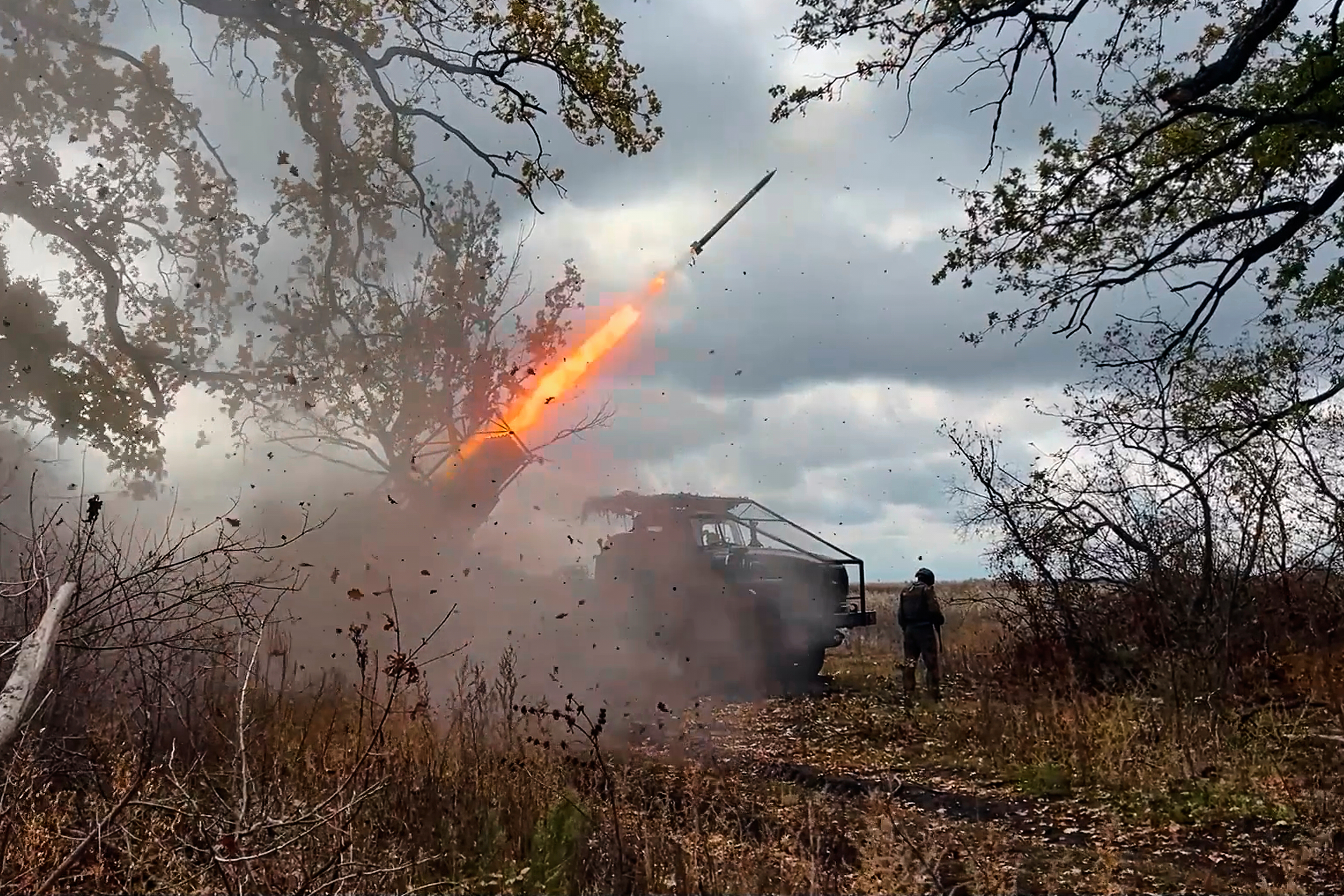 In this image made from video provided by the Russian Defense Ministry Press Service on Friday, Oct. 31, 2025, a Russian "Grad" self-propelled 122 mm multiple rocket launcher fires towards Ukrainian positions on an undisclosed location in Ukraine. (Russian Defense Ministry Press Service via AP)