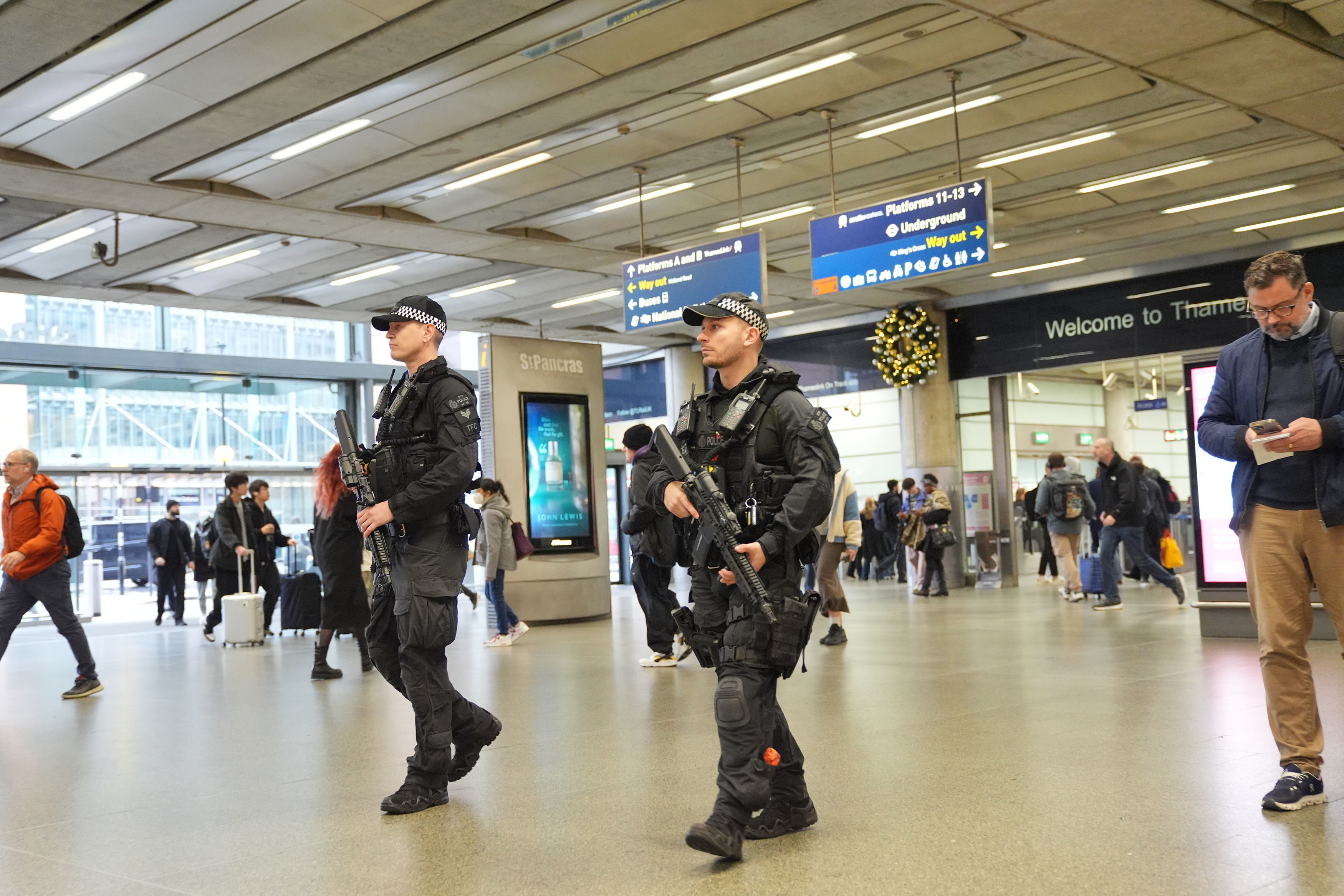 Armed police officers go on patrol at St Pancras International train station in London, England, Monday, Nov. 3, 2025. (Yui Mok/PA via AP)