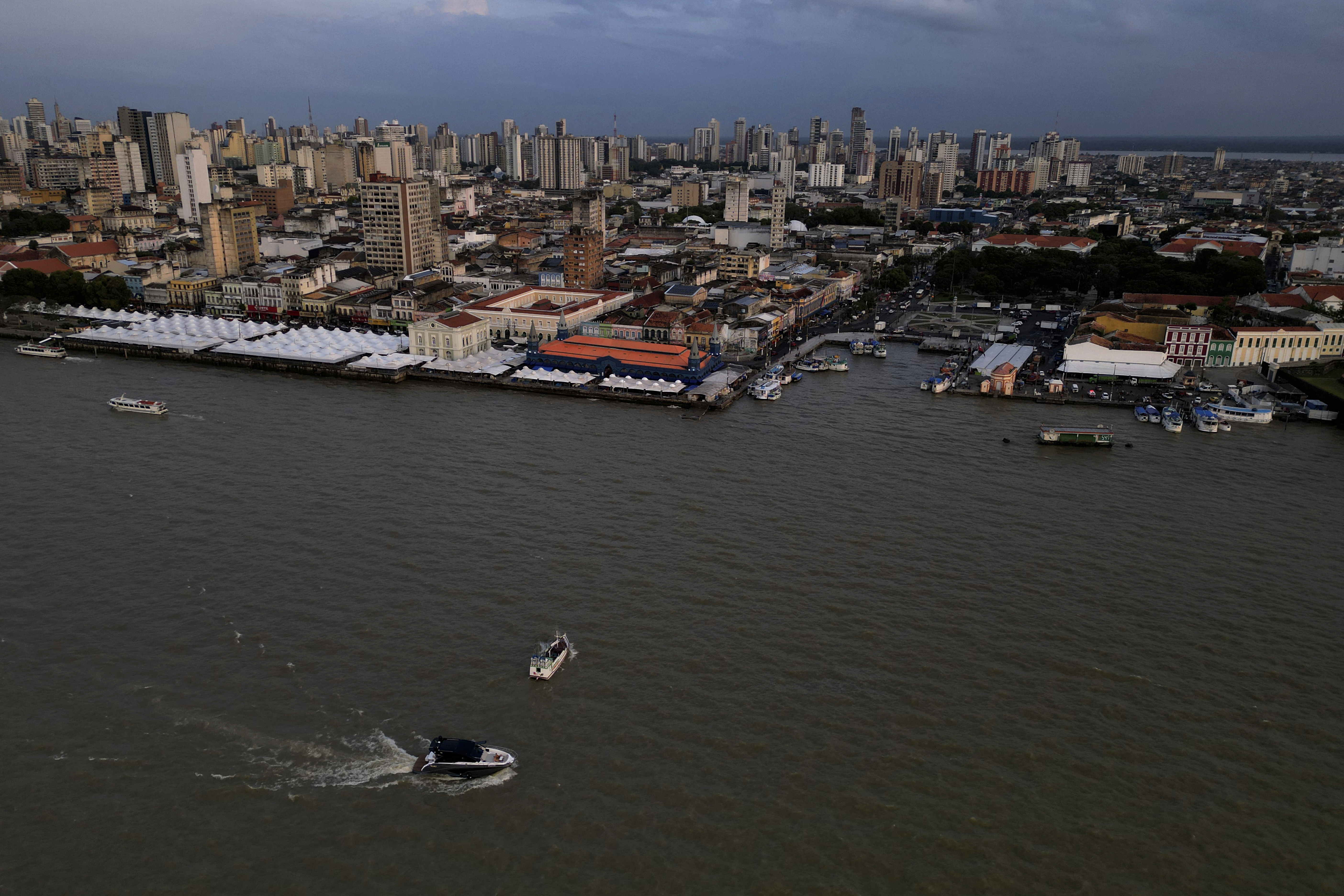 A boat moves through Guajara Bay and historic city of Belem, Para state, Brazil, Friday, Oct. 31, 2025. (AP Photo/Eraldo Peres)