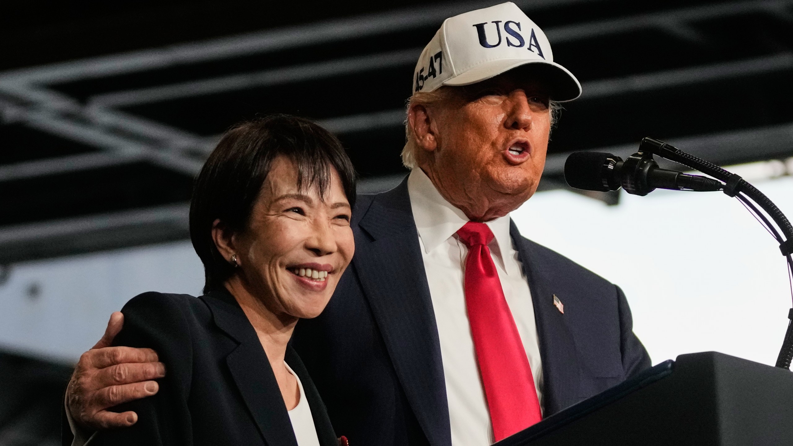 President Donald Trump, with Japanese Prime Minister Sanae Takaichi, speaks to members of the military aboard the USS George Washington, an aircraft carrier docked at an American naval base, in Yokosuka, Tuesday, Oct. 28, 2025. (AP Photo/Mark Schiefelbein)