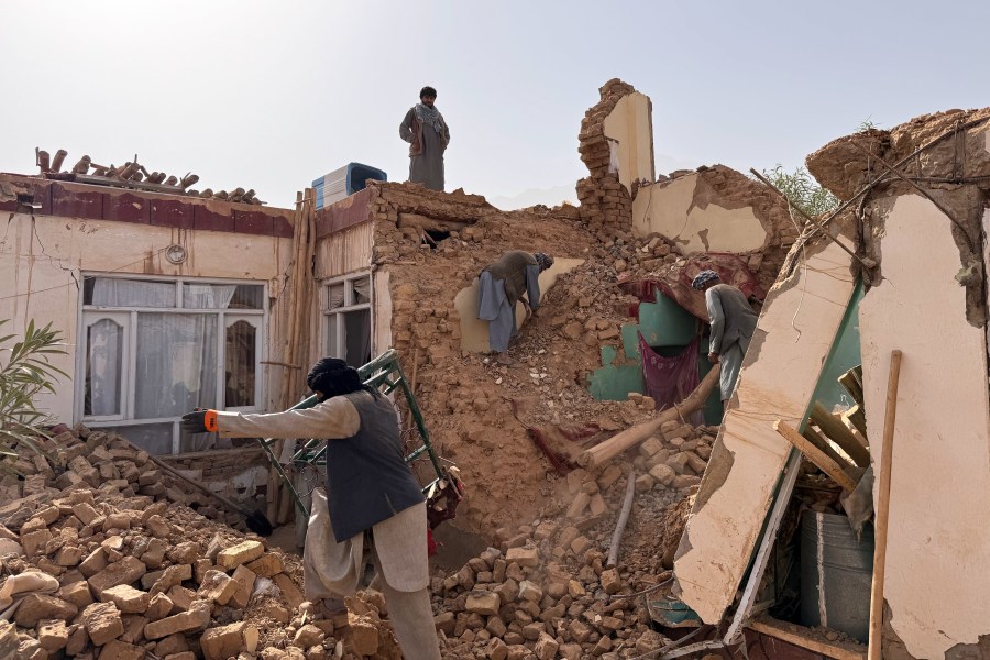 Locals search among the rubble of a destroyed house after a 6.3 powerful in a rural area of the Khulm District, Samangan Province, northern Afghanistan, Monday, Nov. 3, 2025.(AP Photo/Sirat Noori)