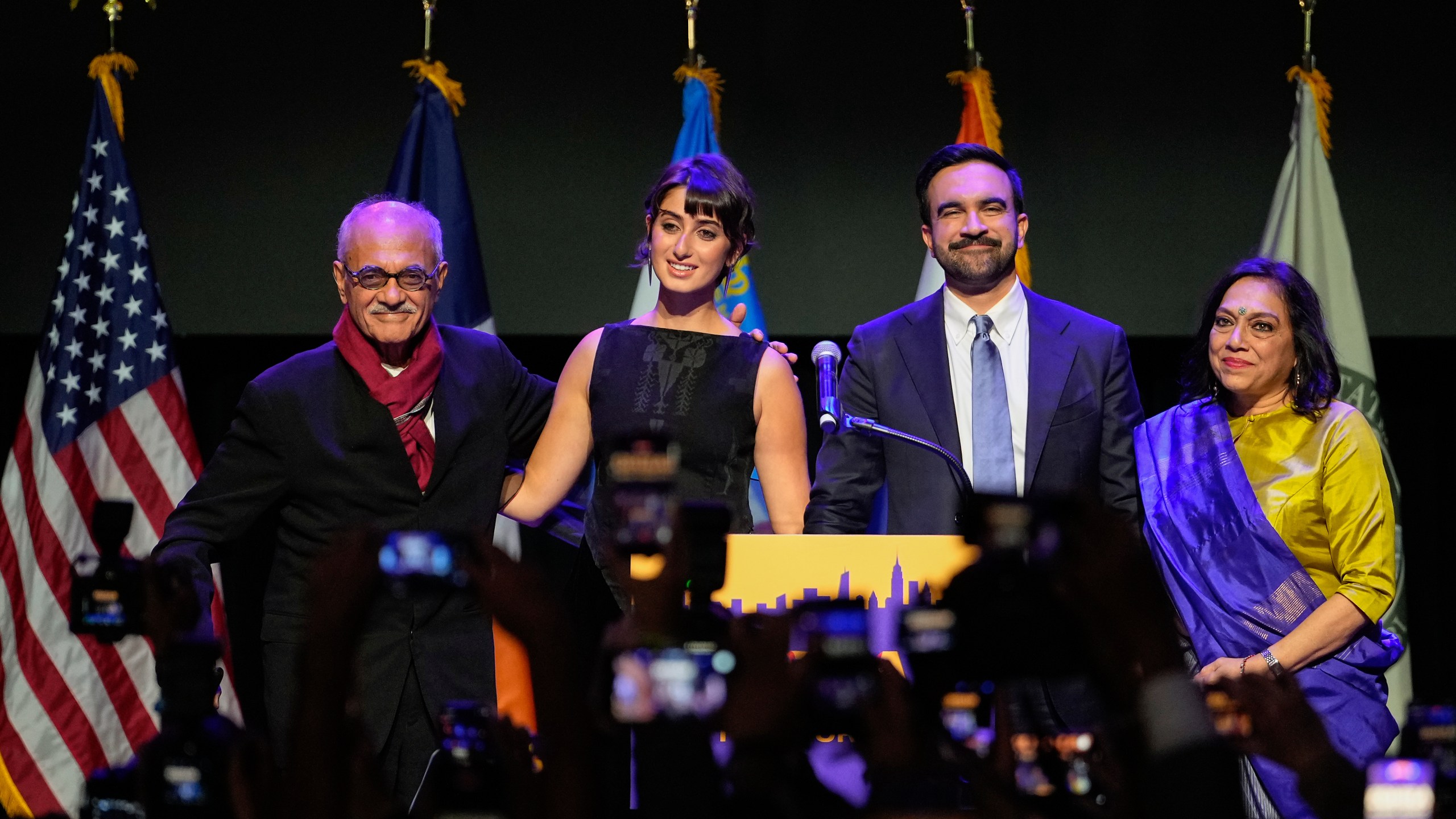 Mayor-elect Zohran Mamdani, second from right, stands on stage with his wife Rama Duwaji, second from left, and his father, Mahmood Mamdani, far left, and mother, Mira Nair, after making an acceptance speech, Tuesday, Nov. 4, 2025, in New York. (AP Photo/Yuki Iwamura)