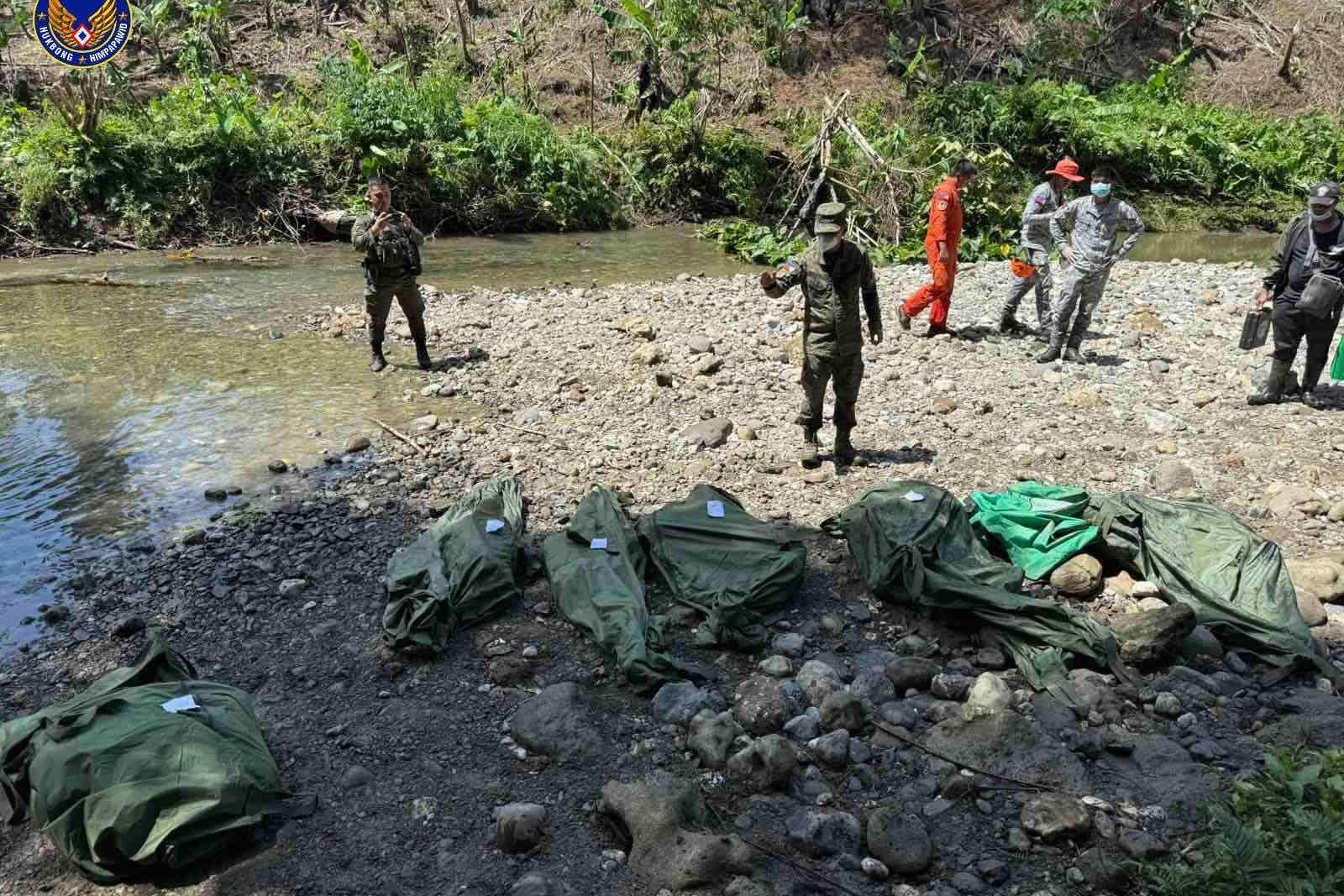 In this photo provided by the Philippine Air Force, Philippine Air Force personnel retrieve the remains of the pilots and crew of the Super Huey helicopter on Wednesday, Nov. 5, 2025, a day after it crashed in Agusan del Sur province, southern Philippines while on a humanitarian and disaster response mission due to Typhoon Kalmaegi. (Philippine Air Force via AP)