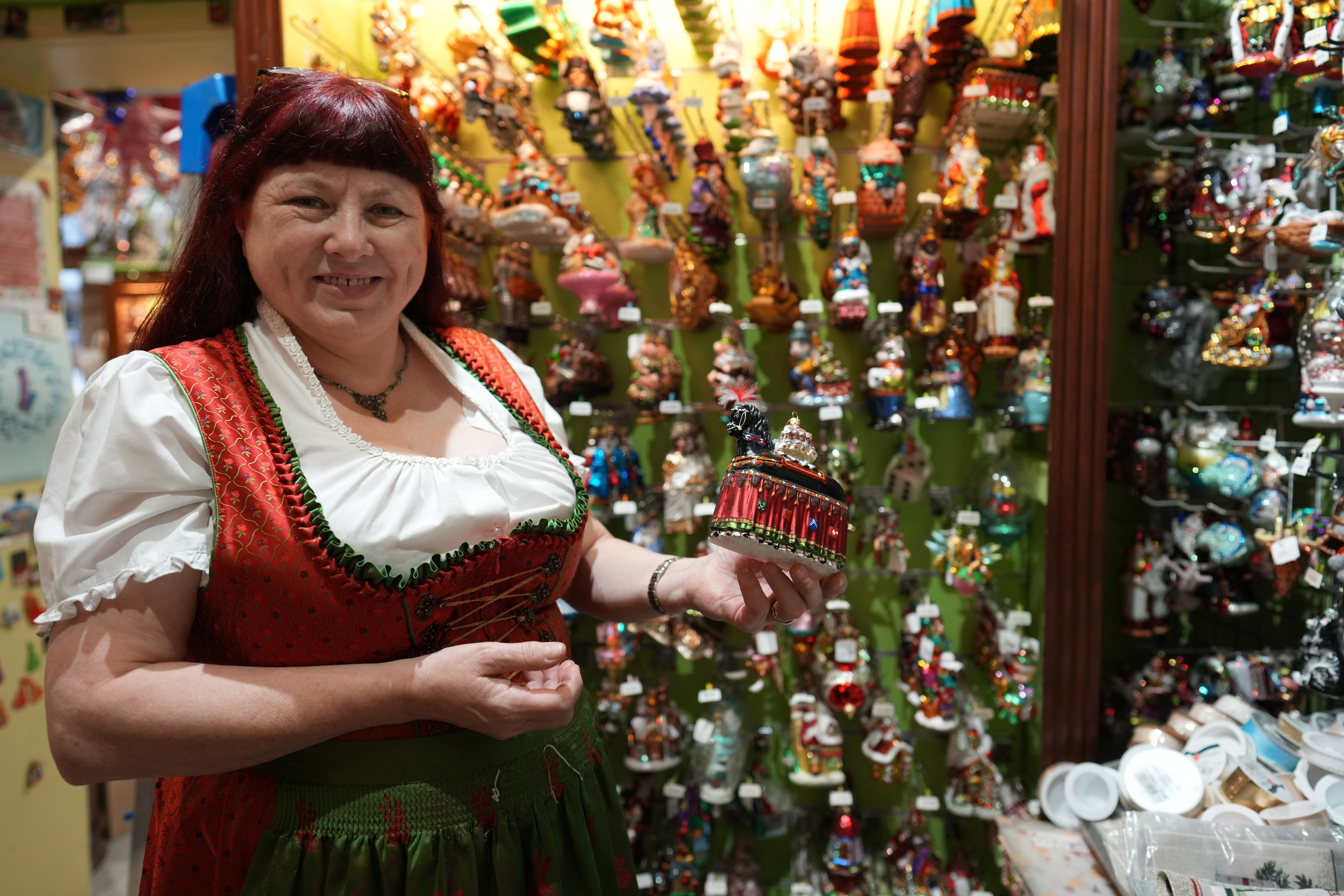 Owner of the Christel Dauwe Collection ornaments shop, Christel Dauwe, shows an ornament of the Horse Bayard, a folkloric Belgian event, at her shop in Antwerp, Belgium, Monday, Dec. 8, 2025. (AP Photo/Virginia Mayo)