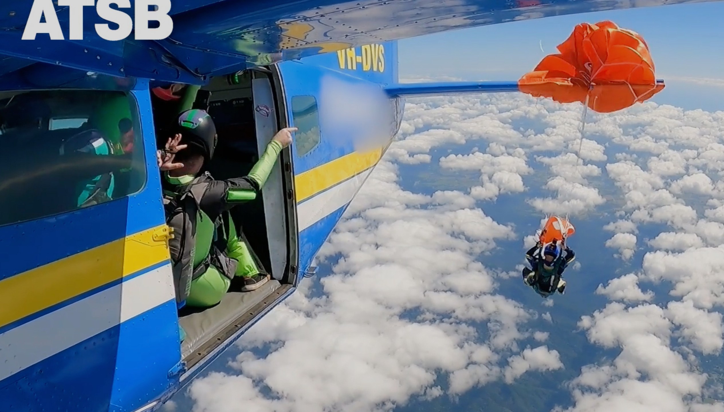 In this image taken from a video a skydiver is caught on the wing of a plane as he exited the aircraft in Tully, North Queensland, Sept.20, 2025.(Jarrad Nolan/Australian Transport Safety Bureau via AP)
