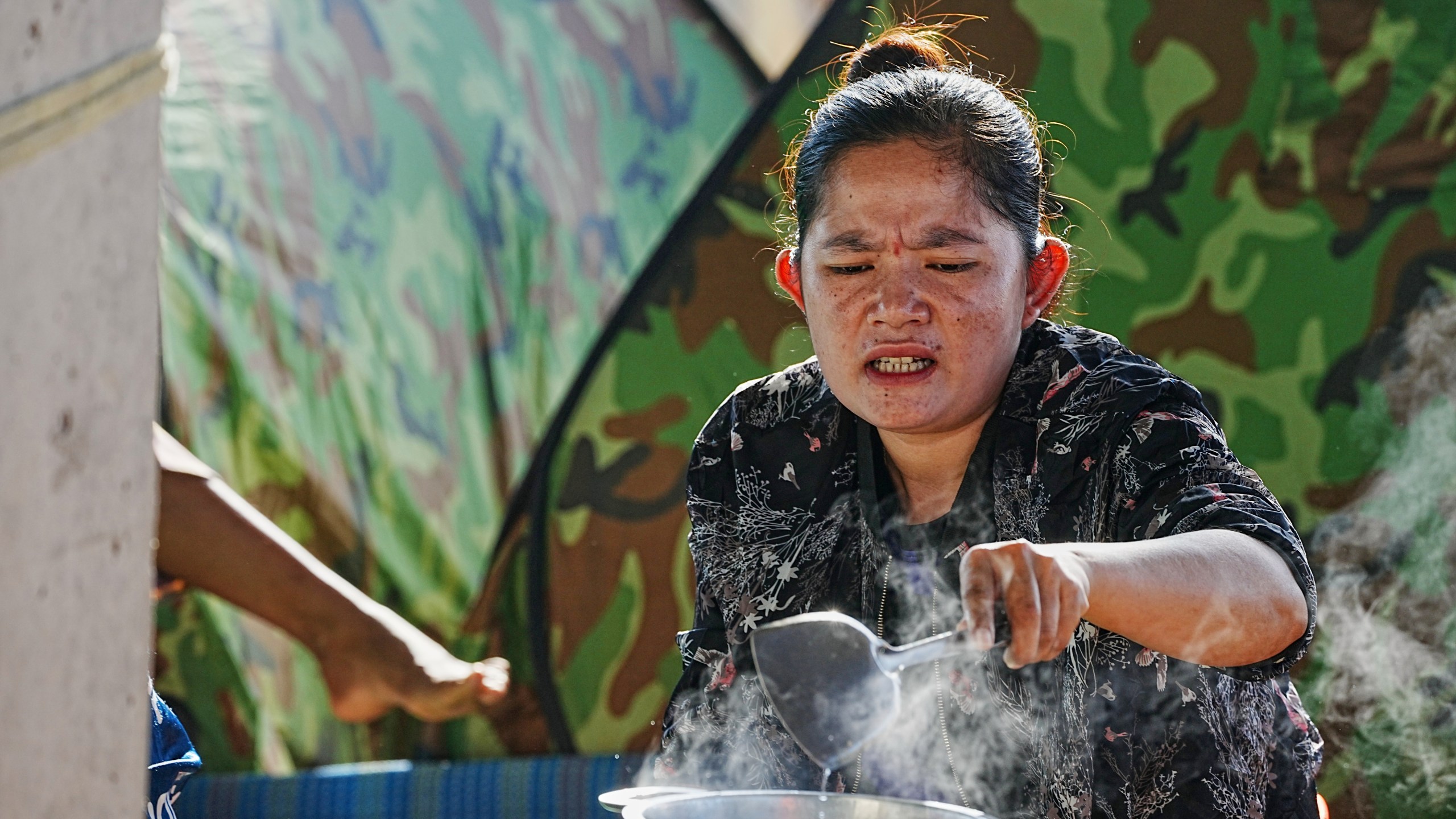 An evacuee cooks soup as she takes refuge in Banteay Menchey provincial town, Cambodia, Saturday, Dec. 13, 2025, after fleeing home following fighting between Thailand and Cambodia. (AP Photo/Heng Sinith)
