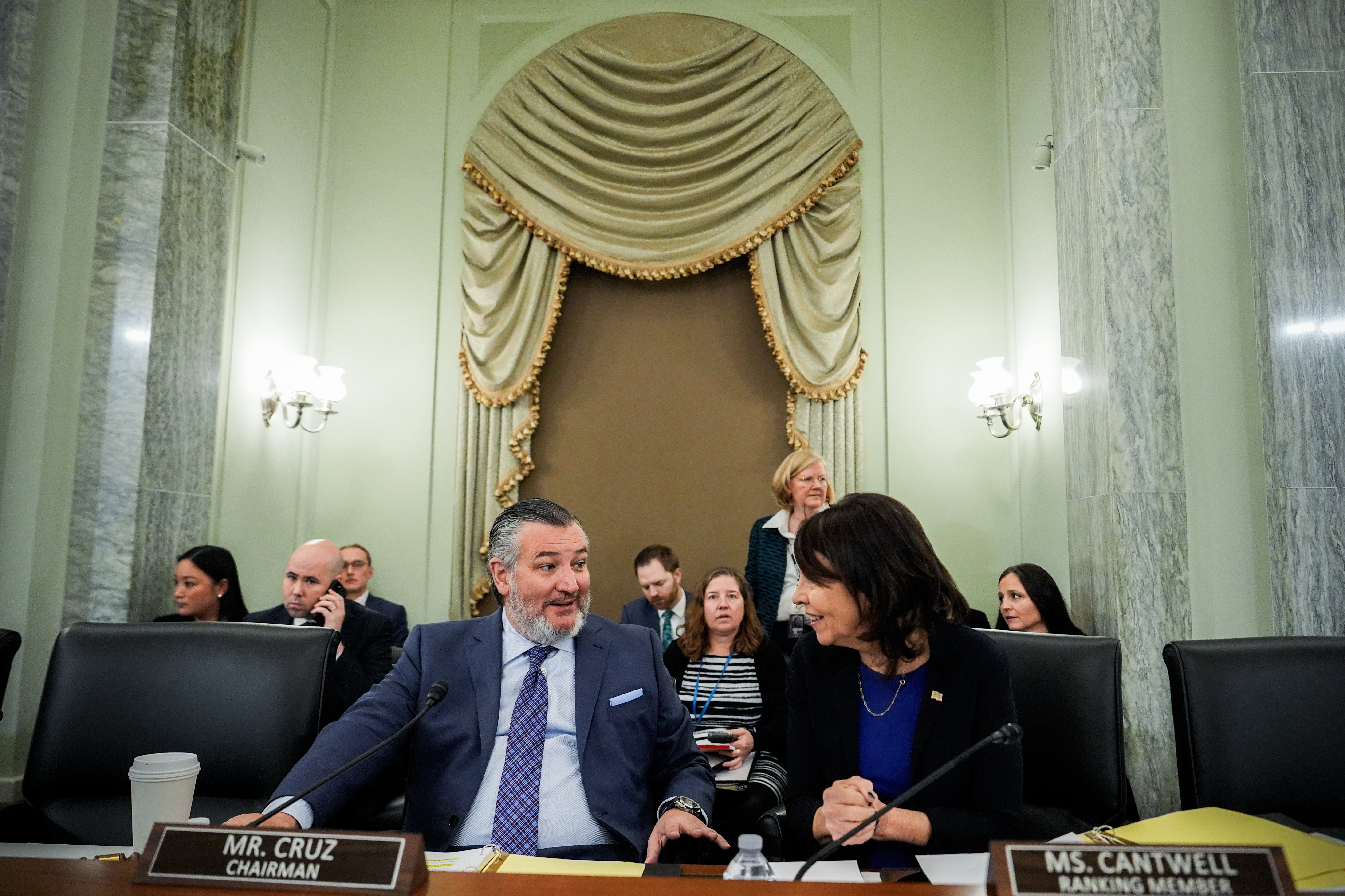 Sen. Ted Cruz, R-Texas, left, chairman of the Senate Commerce, Science and Transportation Committee, speaks with Sen. Maria Cantwell, D-Wash., right, before a hearing on the nomination of Adm. Kevin Lunday, acting commandant of the U.S. Coast Guard, for Commandant of the Coast Guard, Wednesday, Nov. 19, 2025, on Capitol Hill in Washington. (AP Photo/Julia Demaree Nikhinson)