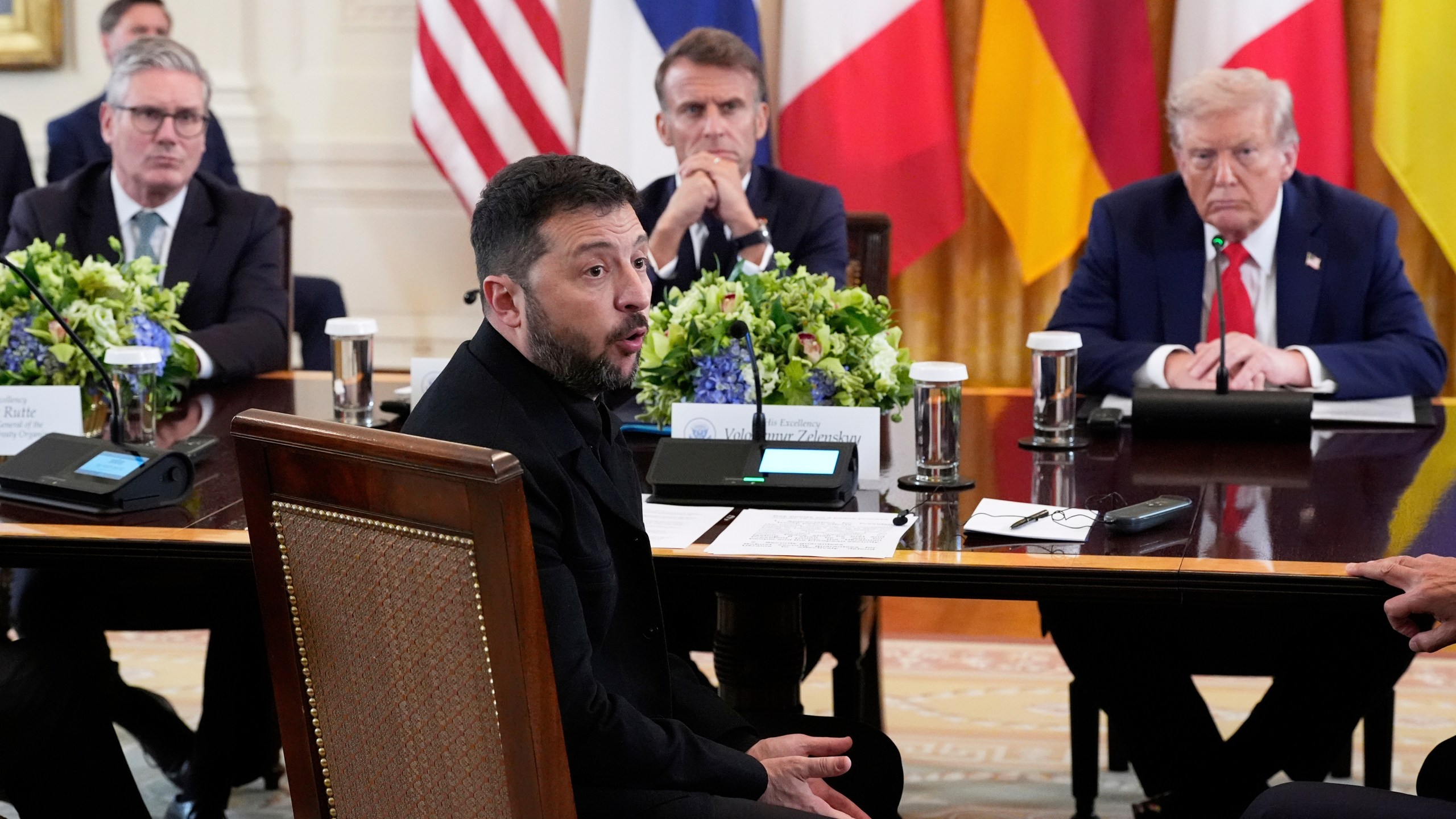 FILE - Ukraine's President Volodymyr Zelenskyy speaks as British Prime Minister Keir Starmer, seated from background left, France's President Emmanuel Macron and President Donald Trump listen during a meeting in the East Room of the White House, Aug. 18, 2025, in Washington. (AP Photo/Alex Brandon, File)