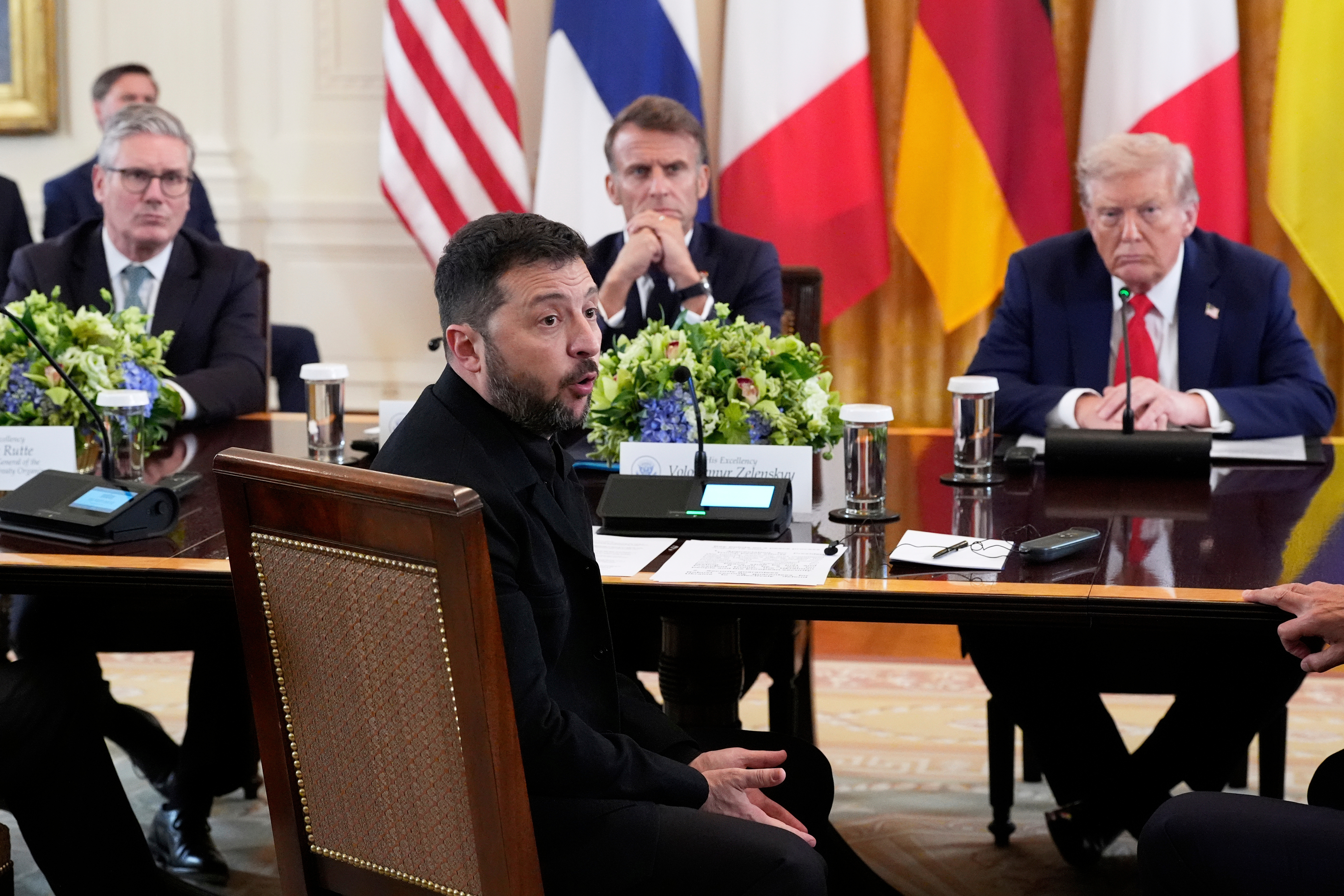 FILE - Ukraine's President Volodymyr Zelenskyy speaks as British Prime Minister Keir Starmer, seated from background left, France's President Emmanuel Macron and President Donald Trump listen during a meeting in the East Room of the White House, Aug. 18, 2025, in Washington. (AP Photo/Alex Brandon, File)