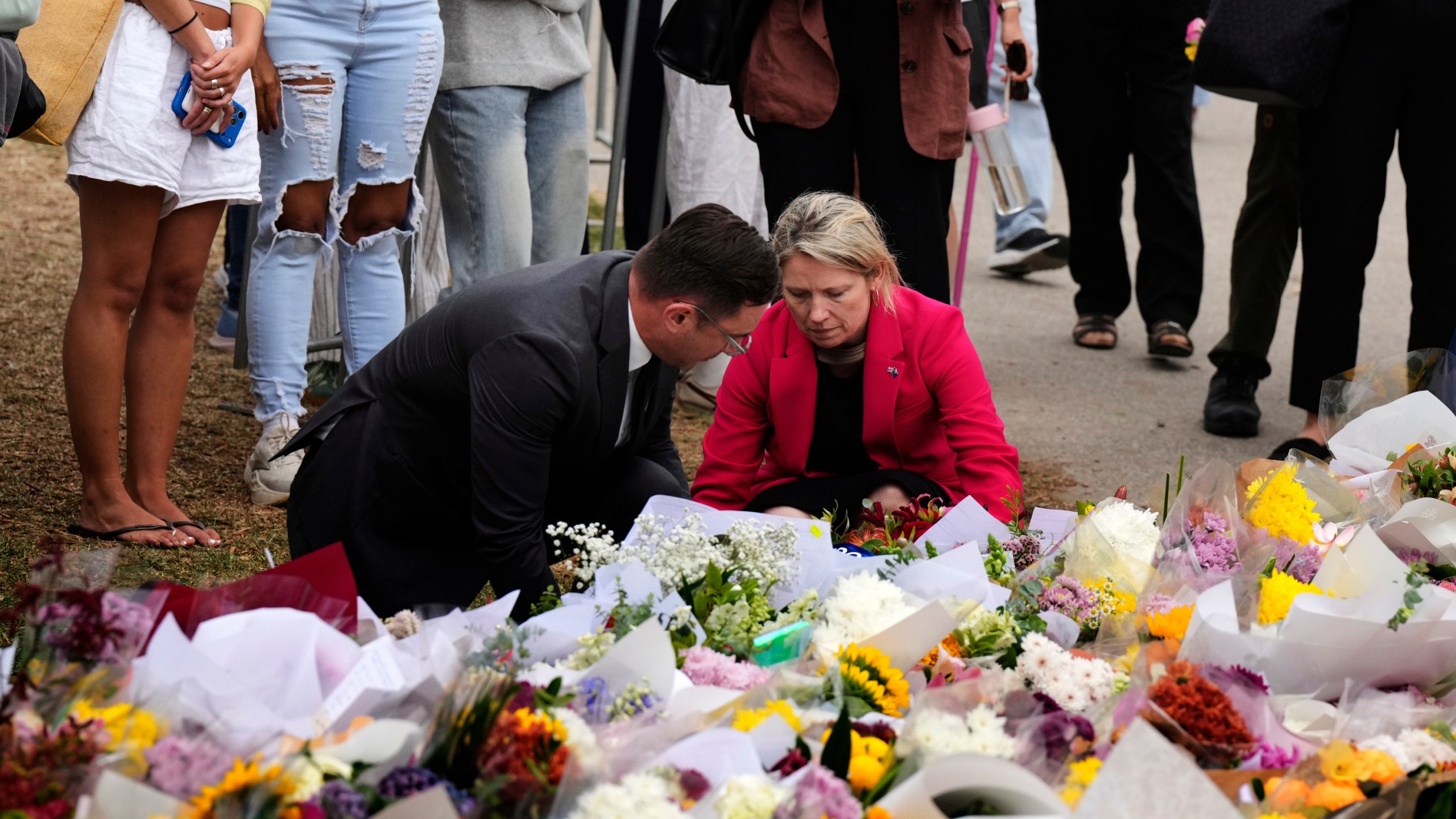 British Consul General Louise Cantillon, lays a wreath at a flower memorial for victims of Sunday's shooting at the Bondi Pavilion at Bondi Beach on Tuesday, Dec. 16, 2025, in Sydney, Australia. (AP Photo/Mark Baker)