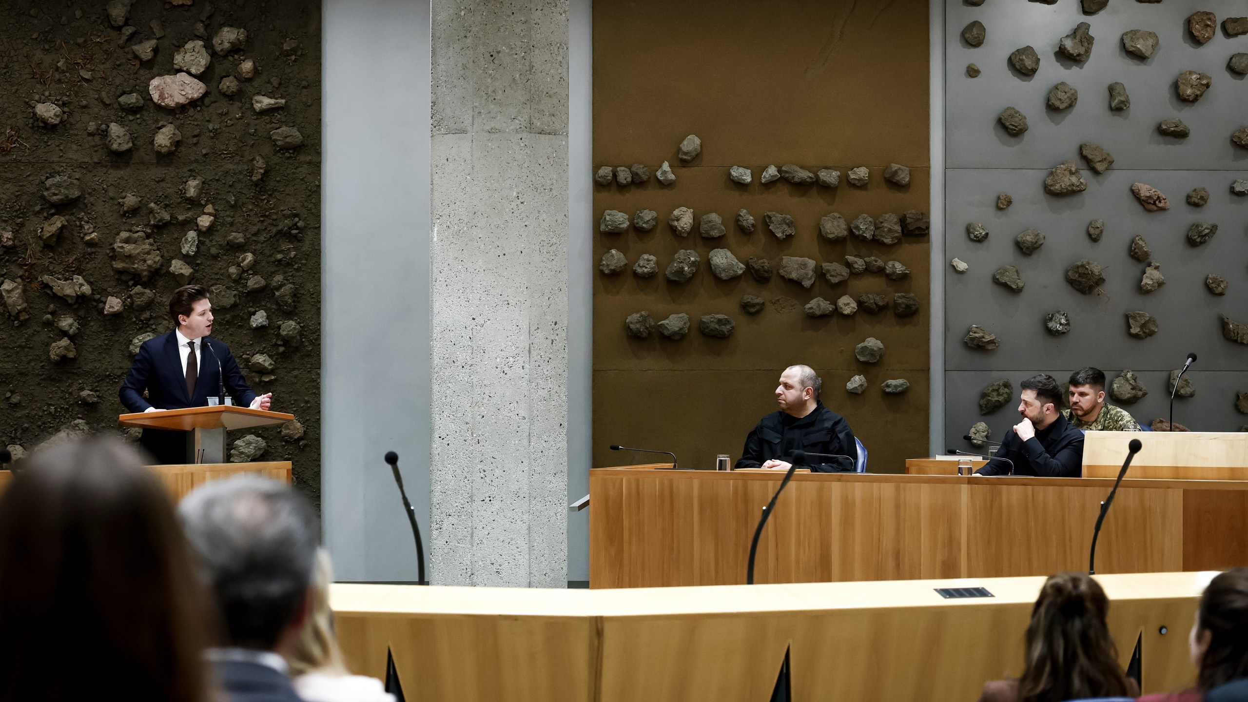 Ukraine's President Volodymyr Zelenskyy, right, attends a parliament session in The Hague, Netherlands, Tuesday, Dec. 16, 2025. (Robin van Lonkhuijsen/Pool Photo via AP)