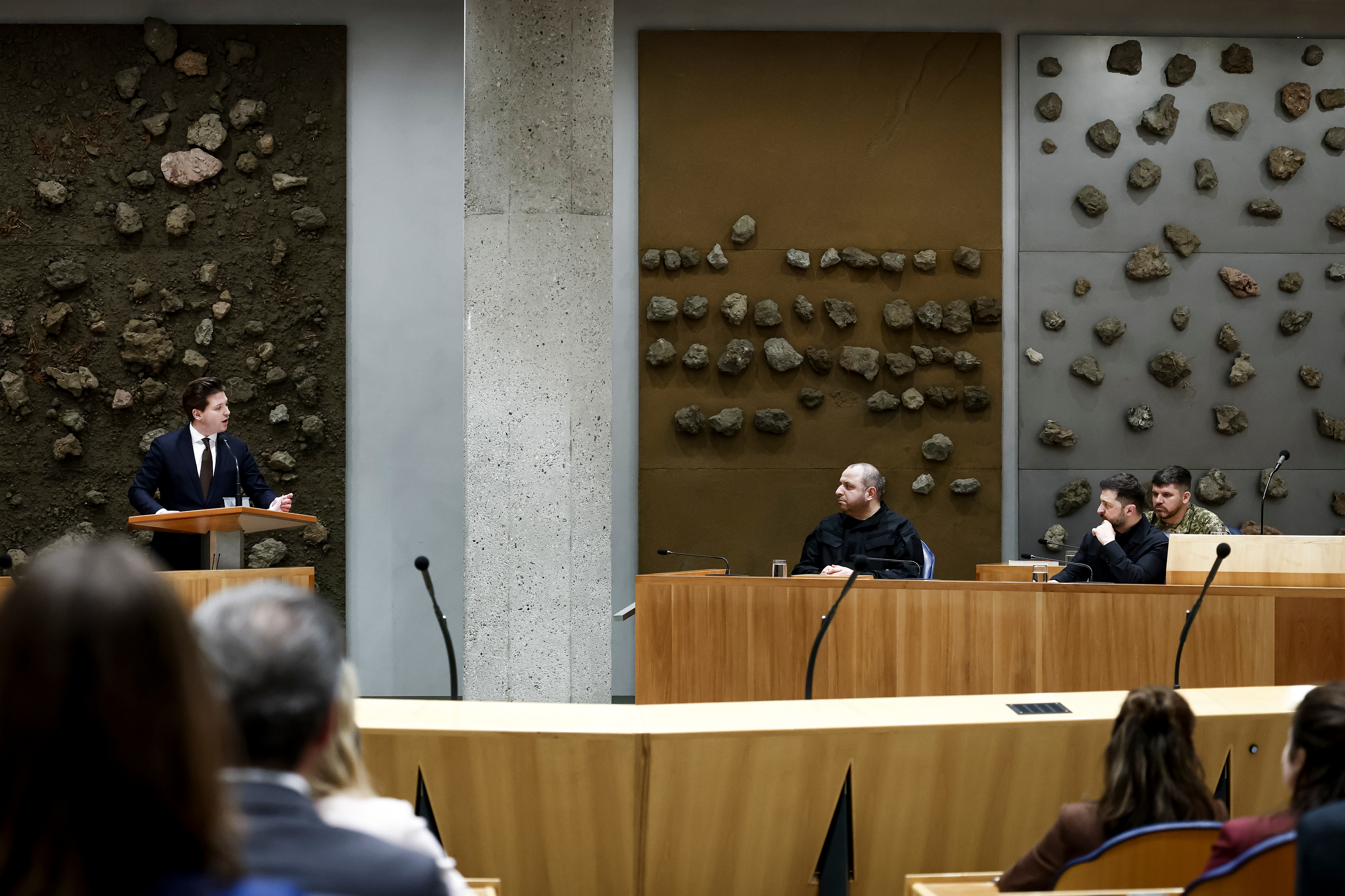 Ukraine's President Volodymyr Zelenskyy, right, attends a parliament session in The Hague, Netherlands, Tuesday, Dec. 16, 2025. (Robin van Lonkhuijsen/Pool Photo via AP)