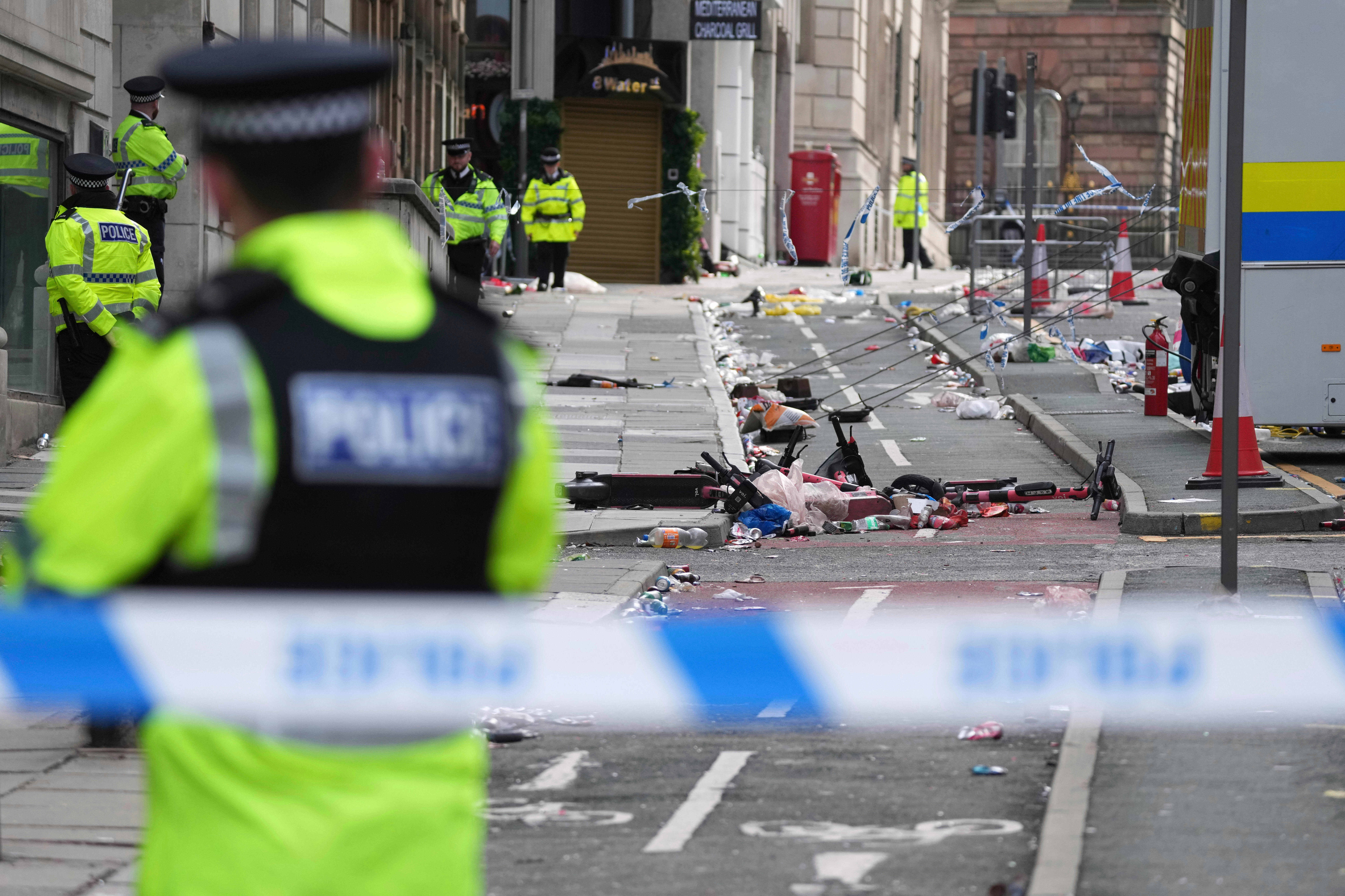 FILE - Police guards the site where a 53-year-old British man plowed a minivan into a crowd of Liverpool soccer fans who were celebrating the city's Premier League championship Monday, injuring more than 45 people in Liverpool, England, Tuesday, May 27, 2025.(AP Photo/Jon Super, File)