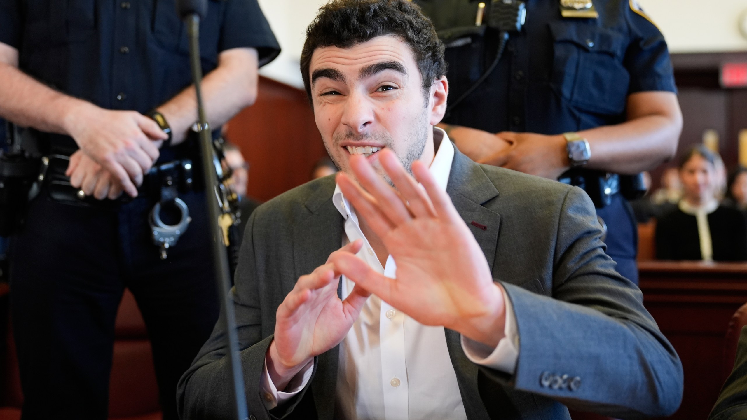 Luigi Mangione talks to a photographer as he appears in court in New York, Tuesday, Dec. 16, 2025. (AP Photo/Seth Wenig, Pool)