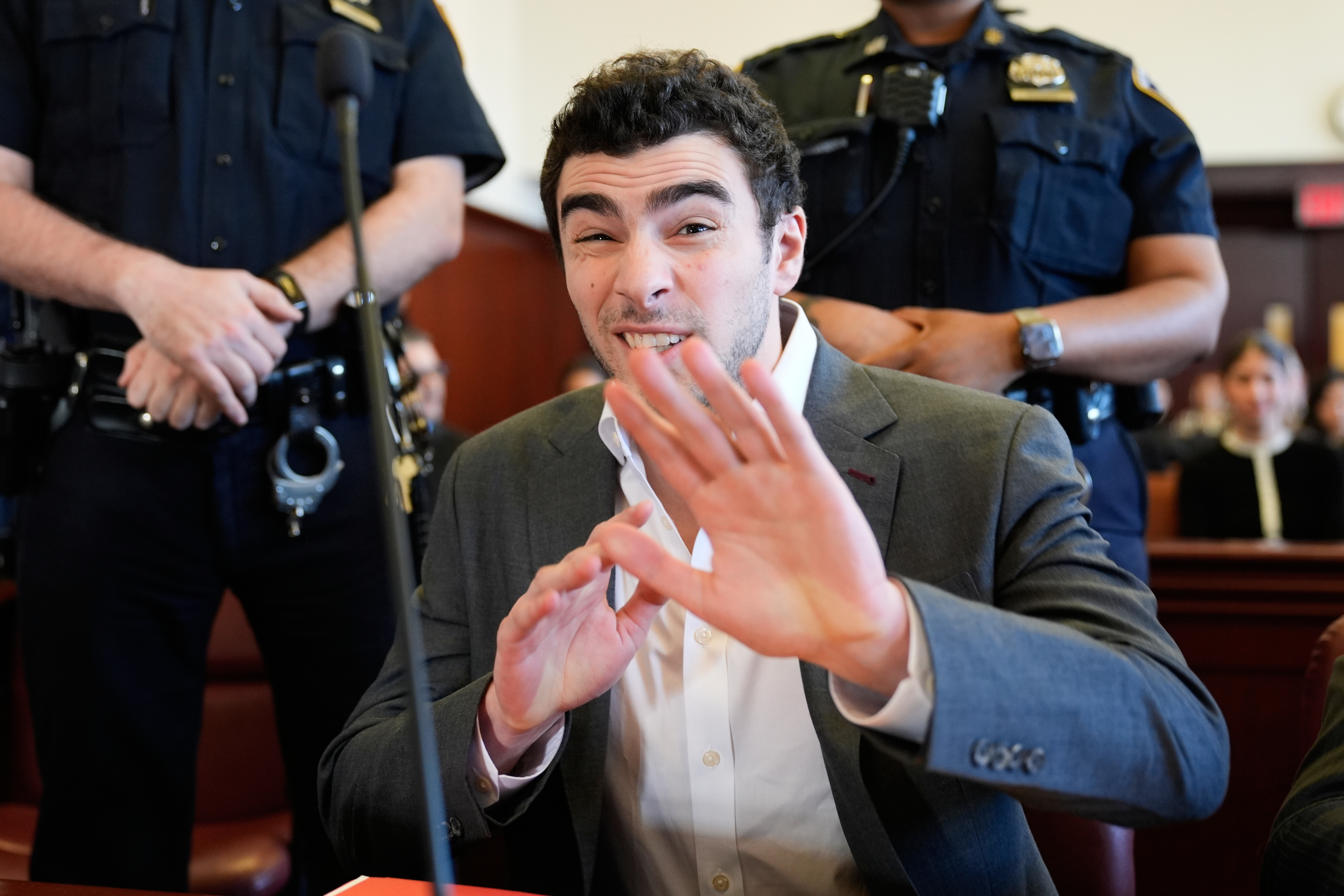 Luigi Mangione talks to a photographer as he appears in court in New York, Tuesday, Dec. 16, 2025. (AP Photo/Seth Wenig, Pool)