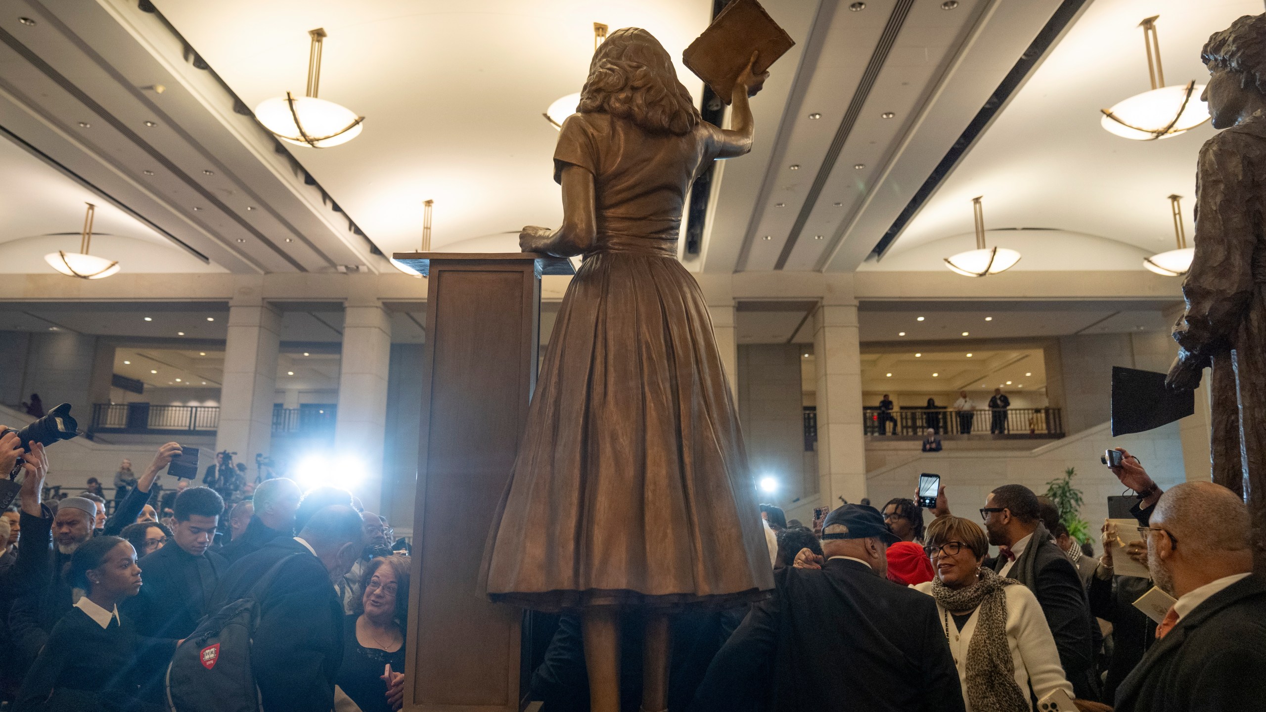People take photos of a statue of Virginia civil rights activist Barbara Rose Johns, whose statue will replace one of Robert E. Lee as one of Virginia's two statues on display at the Capitol, at a dedication ceremony Tuesday, Dec. 16, 2025, in Washington. (AP Photo/Mark Schiefelbein)