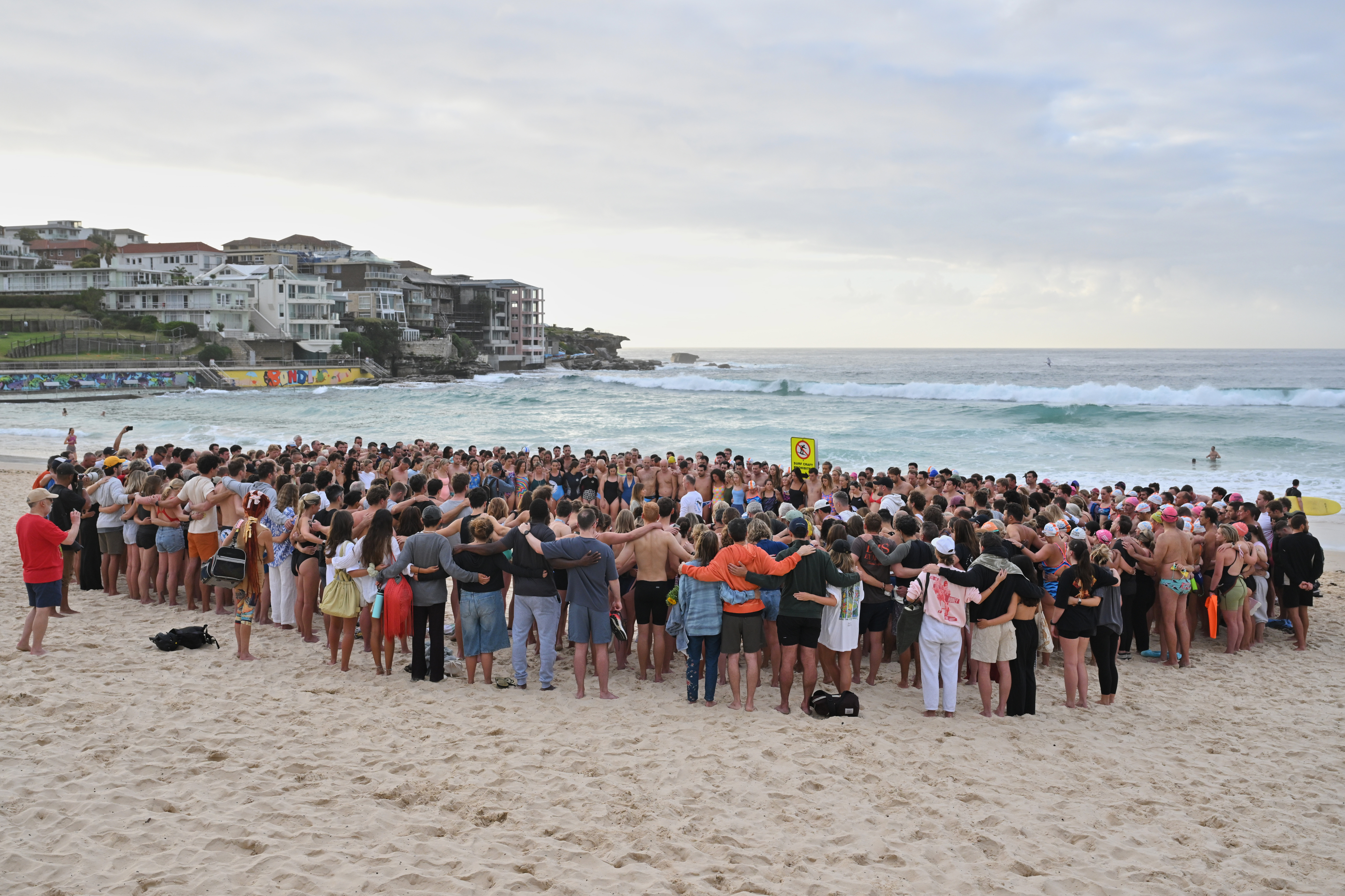 Swimmers gather for a morning vigil in Sydney, Wednesday, Dec. 17, 2025, following Sunday's shooting at Bondi Beach. (Mick Tsikas/AAP Image via AP)/AAP Image via AP)