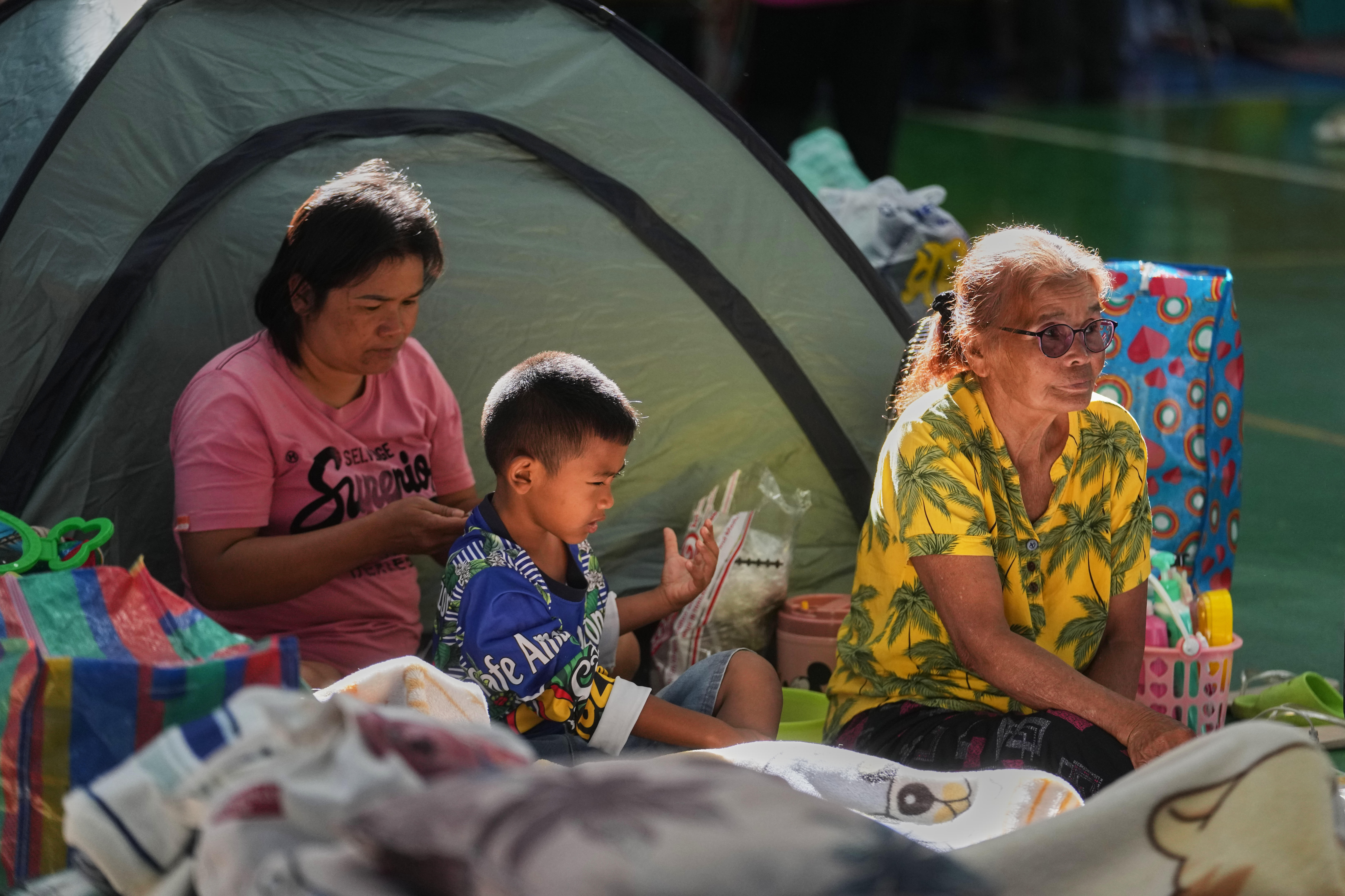 Thai residents who fled homes from fighting between Thailand and Cambodia along the border rest at an evacuation center in Surin province, Thailand, Tuesday, Dec. 16, 2025, (AP Photo/Sakchai Lalit)