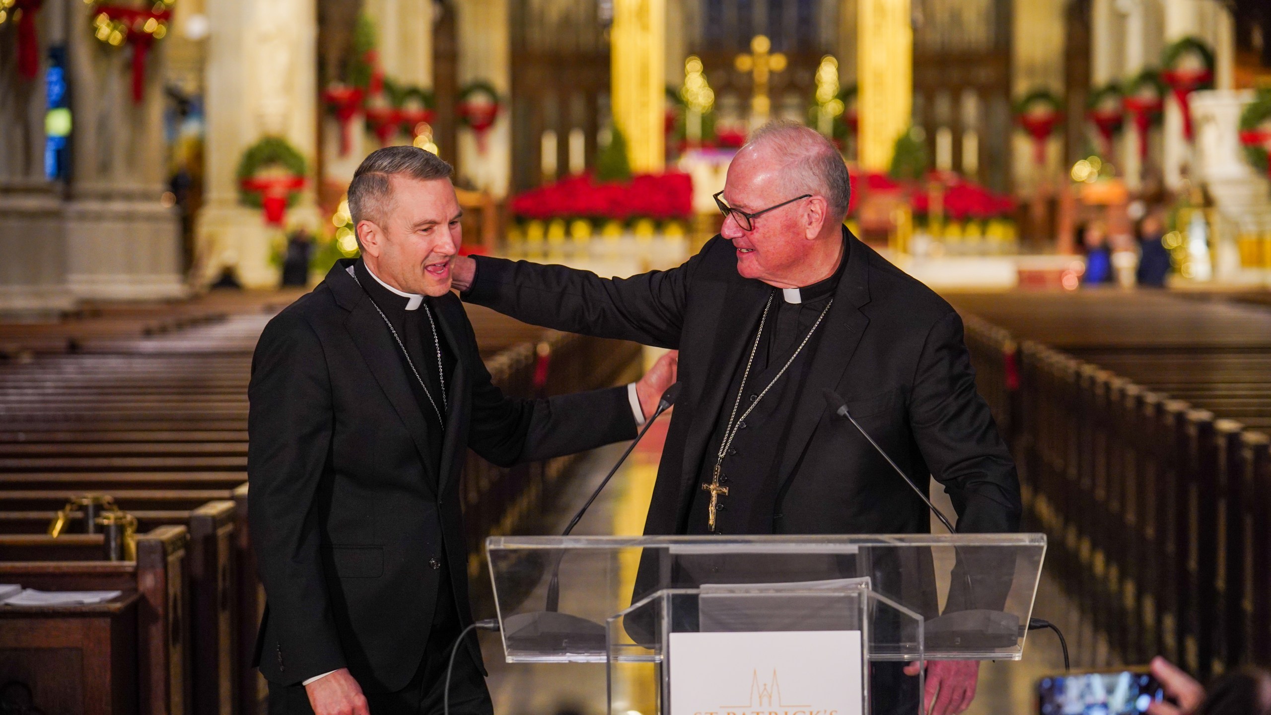 New York Archbishop, Timothy Dolan, right, greets Bishop Ronald Hicks during a news conference, Thursday, Dec.18, 2025 in New York. (AP Photo/Ryan Murphy)