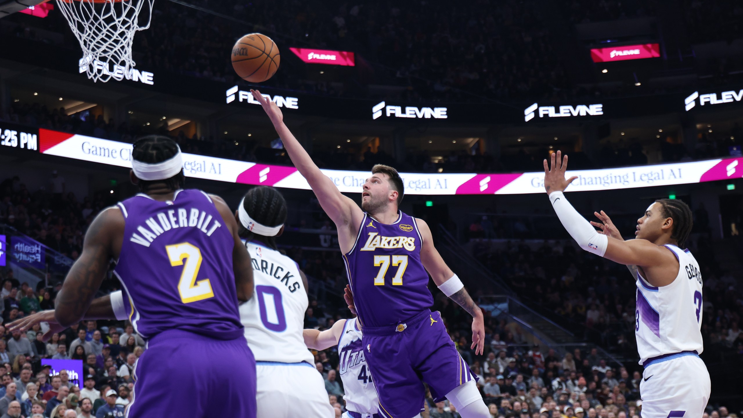 Los Angeles Lakers guard Luka Doncic (77) lays up the ball against the Utah Jazz during the first quarter of an NBA basketball game Thursday, Dec. 18, 2025, in Salt Lake City. (AP Photo/Rob Gray)