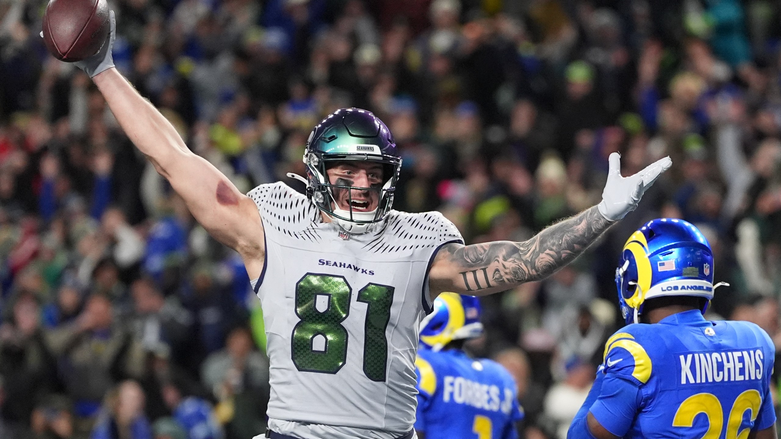 Seattle Seahawks tight end Eric Saubert (81) celebrates after making a two-point conversion during overtime in an NFL football game against the Los Angeles Rams, Thursday, Dec. 18, 2025, in Seattle. (AP Photo/Lindsey Wasson)