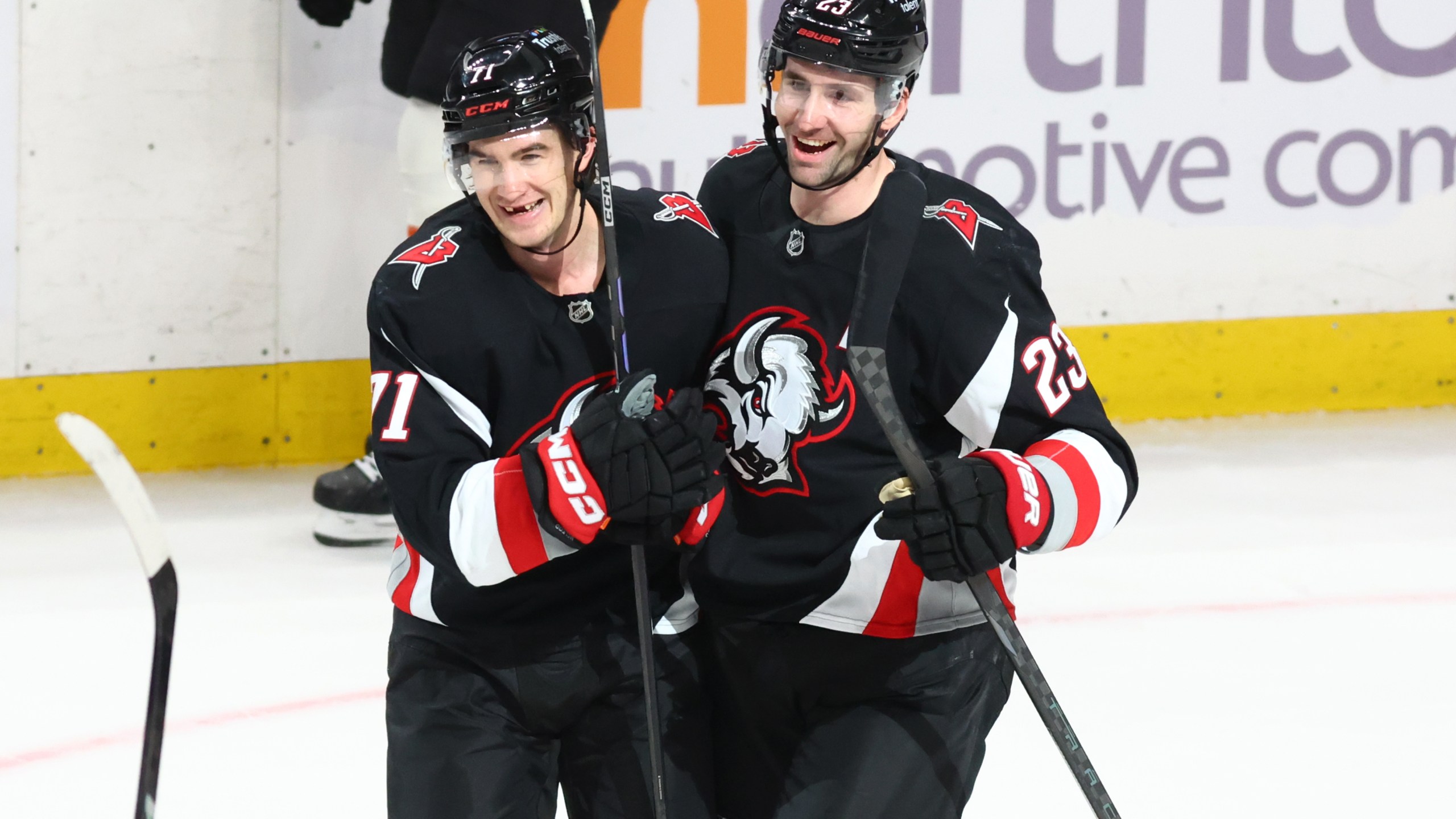 Buffalo Sabres center Ryan McLeod, left, celebrates his empty net goal with defenseman Mattias Samuelsson (23) during the third period of an NHL hockey game against the Philadelphia Flyers, Thursday, Dec. 18, 2025, in Buffalo, N.Y. (AP Photo/Jeffrey T. Barnes)