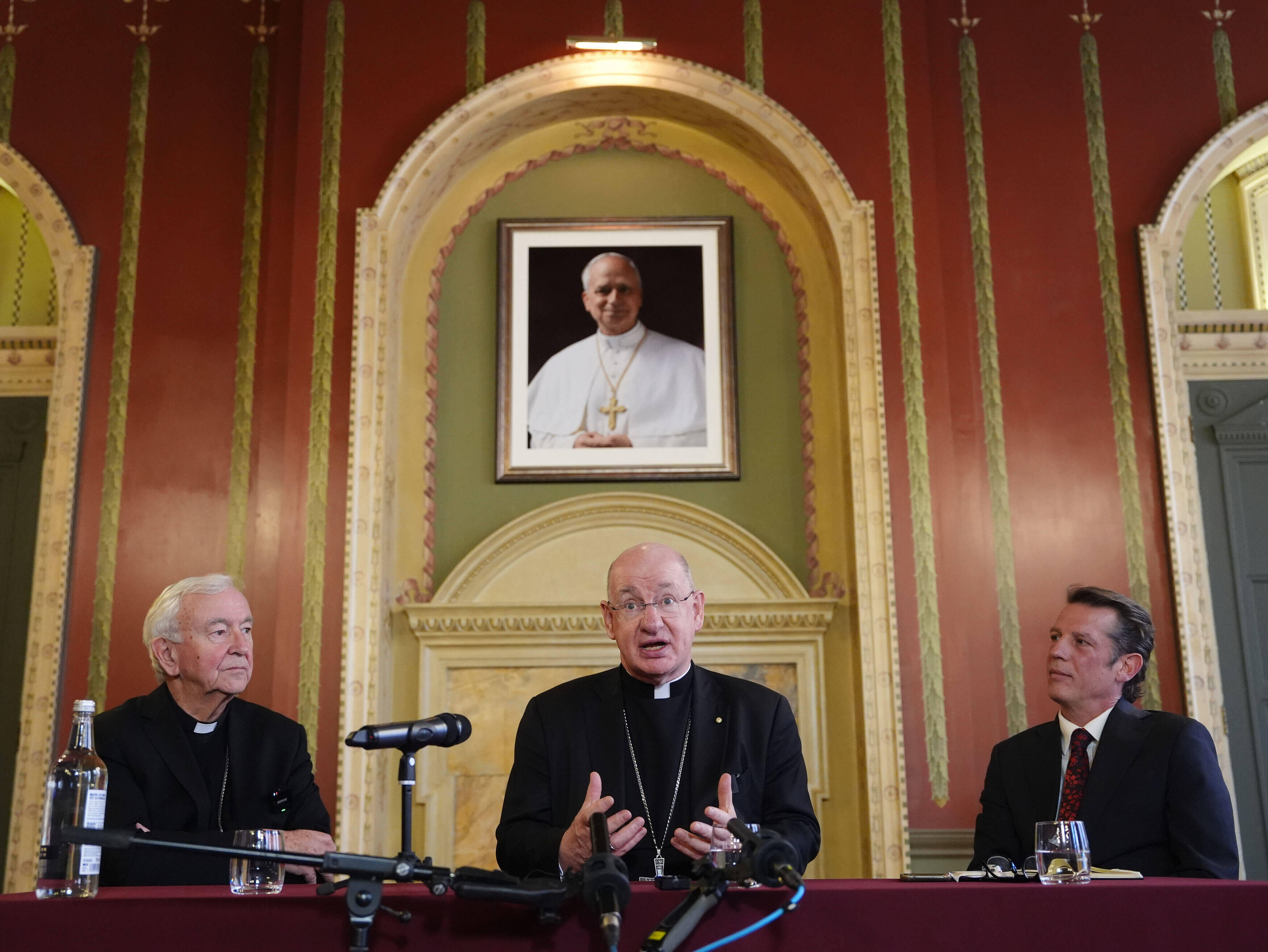 From left, outgoing archbishop of Westminster Cardinal Vincent Nichols, Bishop Richard Moth and the cardinal's press secretary Alexander des Forges sit, during a press conference announcing Bishop Moth as the new Archbishop, replacing Cardinal Nichols as the leader of the Catholic Church in England and Wales, in the Throne Room of Archbishop's House, Westminster, London, Friday, Dec. 19, 2025. (Jonathan Brady/PA via AP)