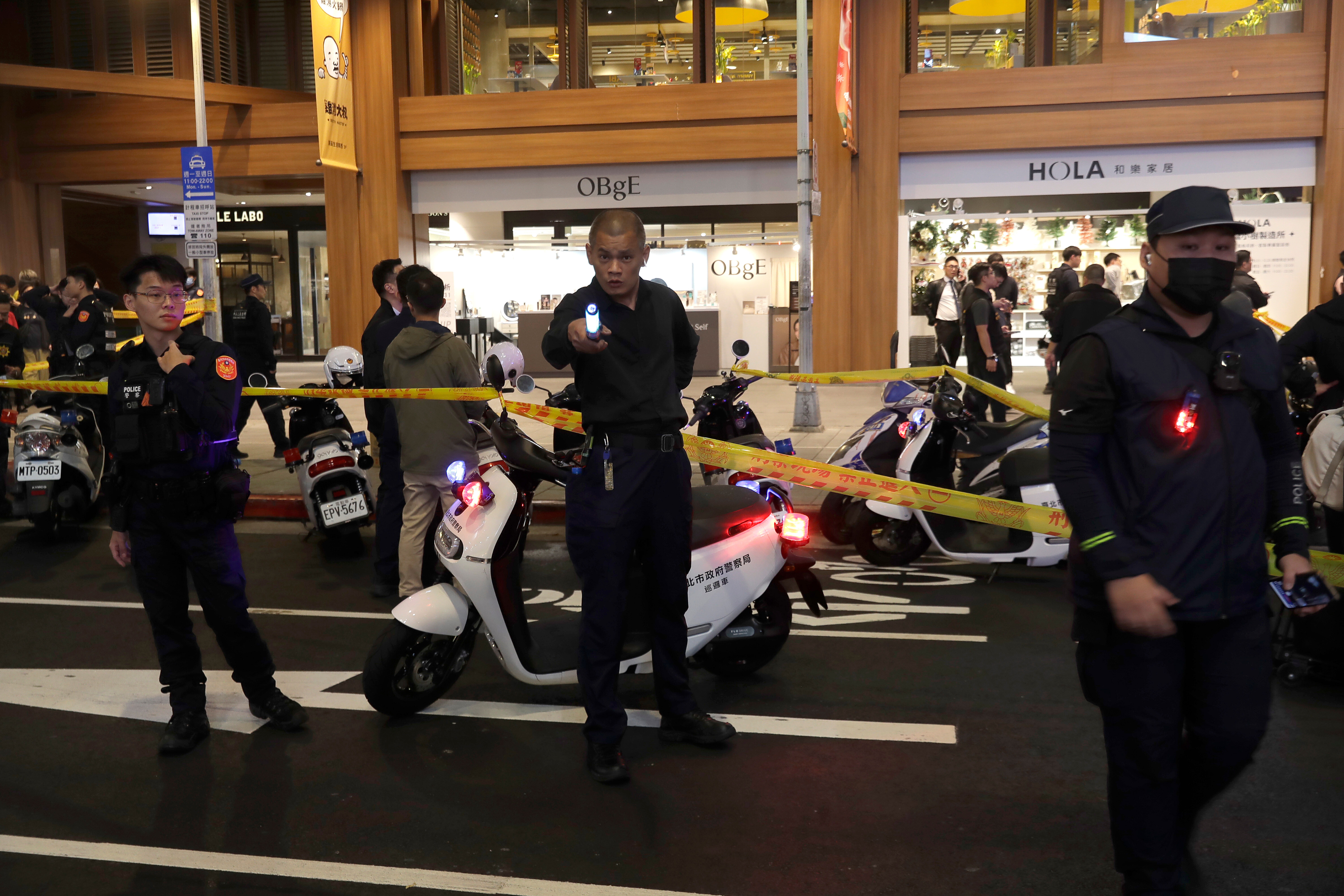 Taiwan police cordoned off the scene after a knife attack in Taipei, Taiwan, Friday, Dec. 19, 2025. (AP Photo/Chiang Ying-ying)