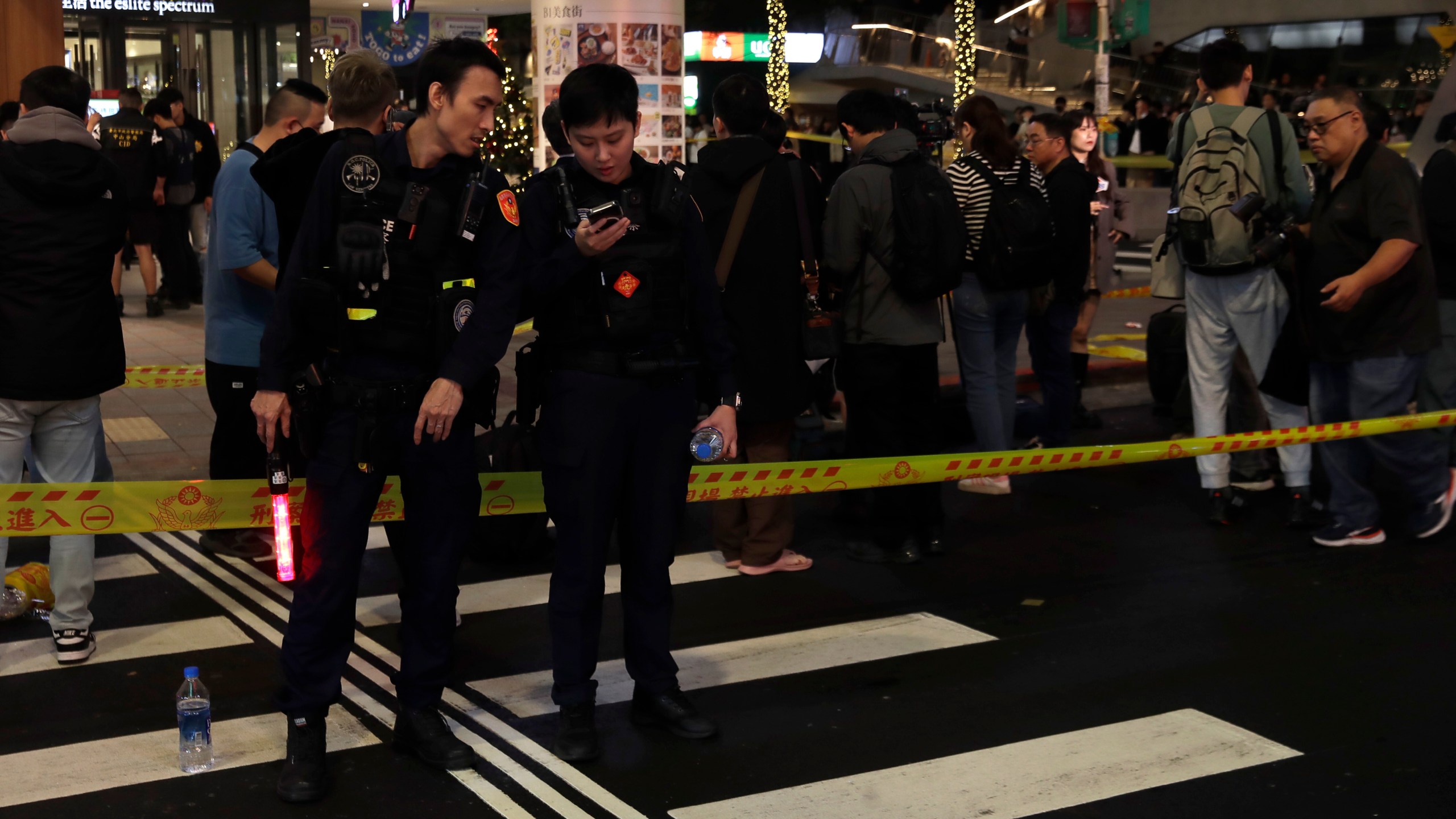 Taiwan police cordoned off the scene after a knife attack in Taipei, Taiwan, Friday, Dec. 19, 2025. (AP Photo/Chiang Ying-ying)