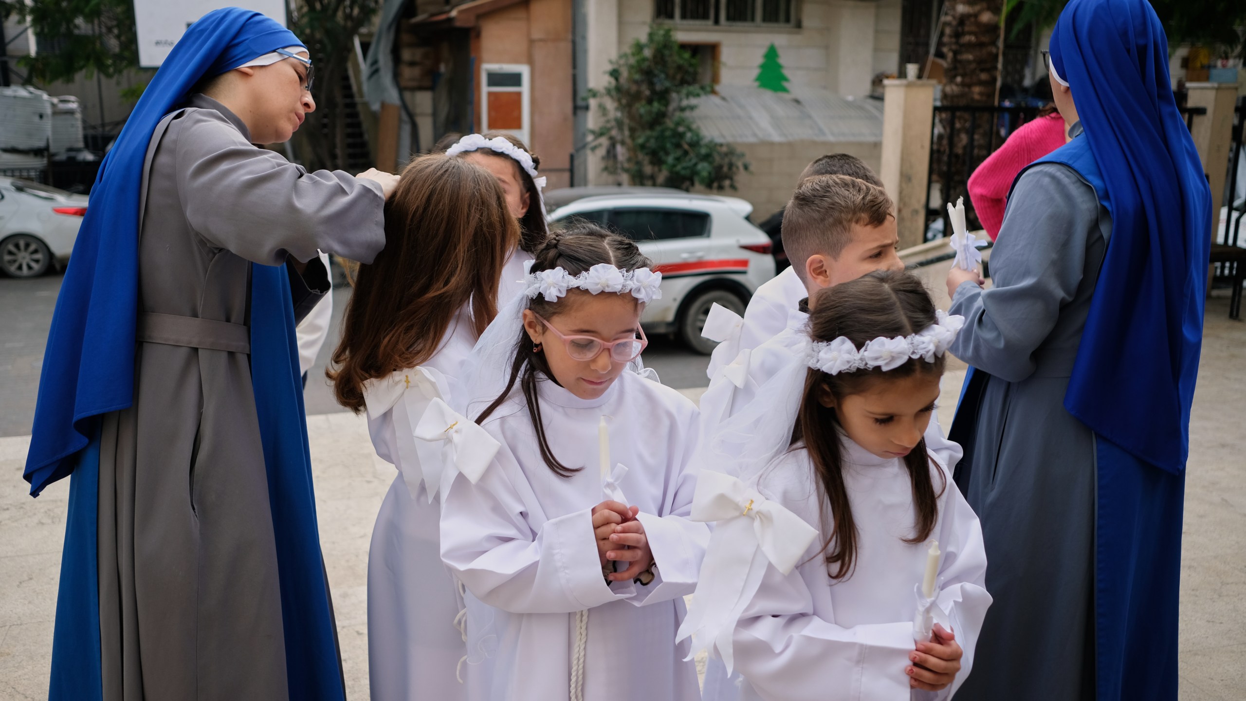 Children and nuns gather outside the Holy Family Catholic Church before attending a mass ahead of Christmas celebrations in Gaza City, Sunday, Dec. 21, 2025. (AP Photo/Jehad Alshrafi)