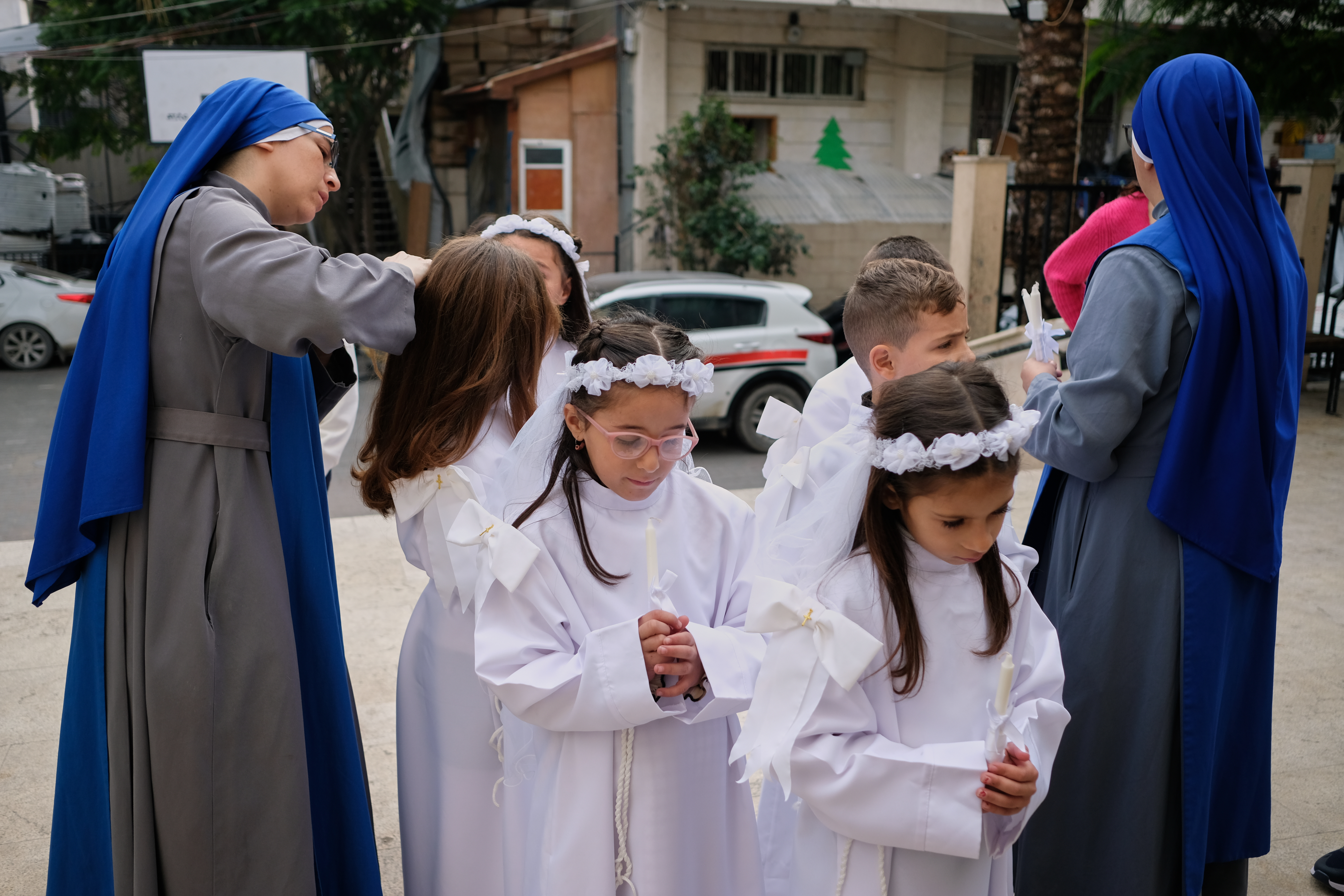 Children and nuns gather outside the Holy Family Catholic Church before attending a mass ahead of Christmas celebrations in Gaza City, Sunday, Dec. 21, 2025. (AP Photo/Jehad Alshrafi)