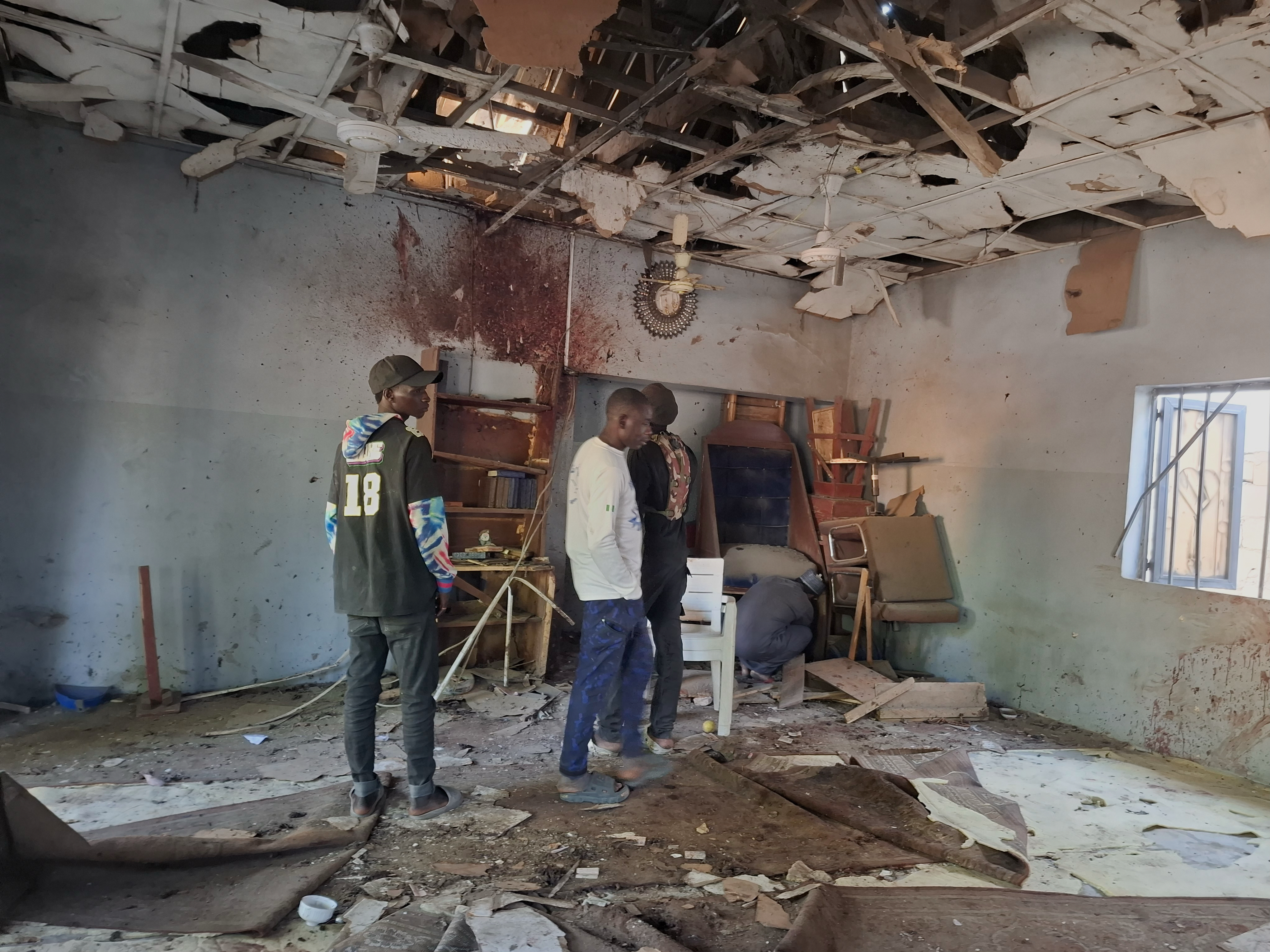 People inspect the scene of a deadly bomb explosion inside a mosque in Maiduguri, Nigeria, Thursday, Dec. 25, 2025. (AP Photo/Jossy Ola )