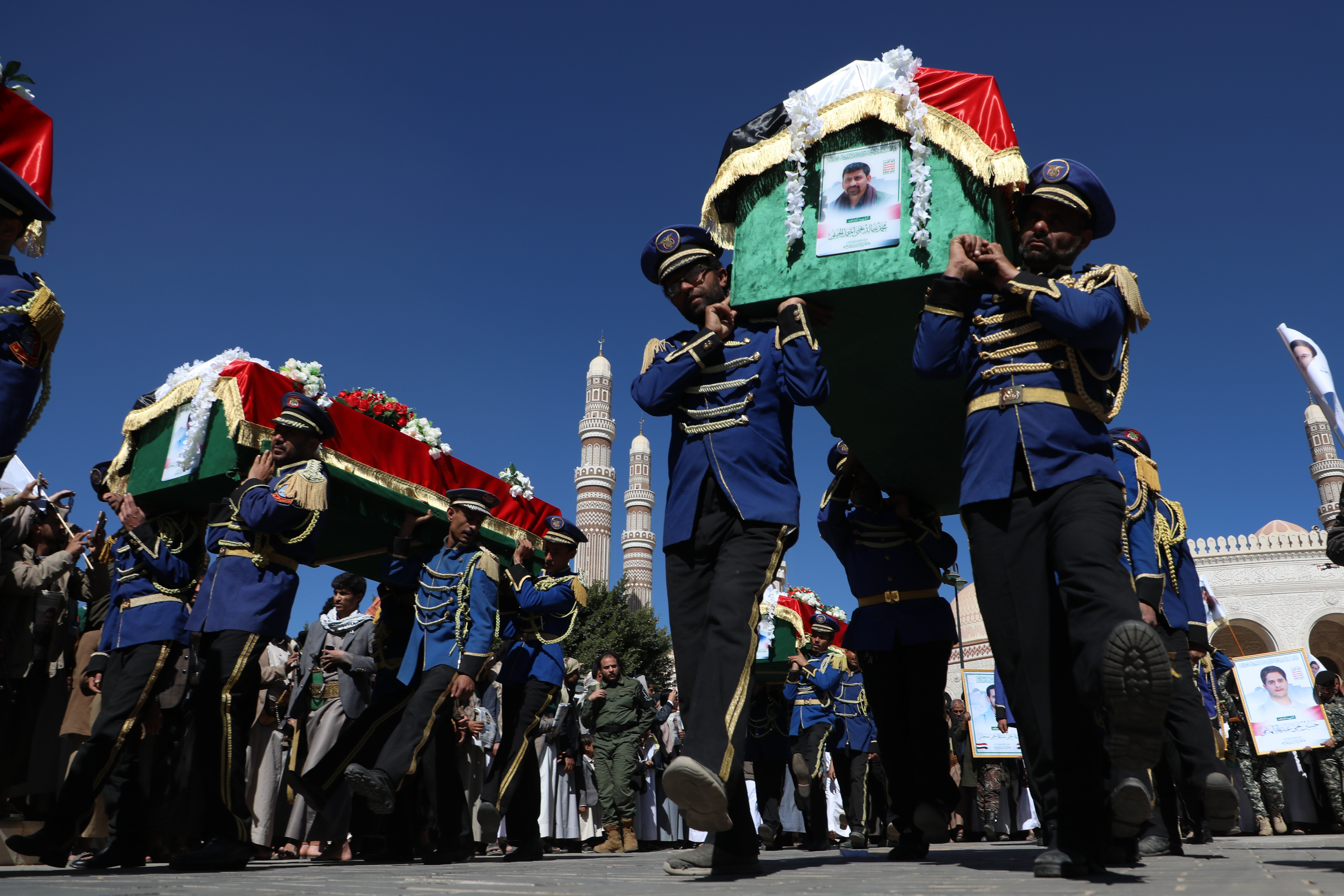 Houthi supporters carry the coffins of 5 leaders, who they said were killed during previous Israeli airstrikes, during a funeral at the people's mosque in Sanaa, Yemen, Thursday, Dec. 25, 2025. (AP Photo/Osamah Abdulrahman)