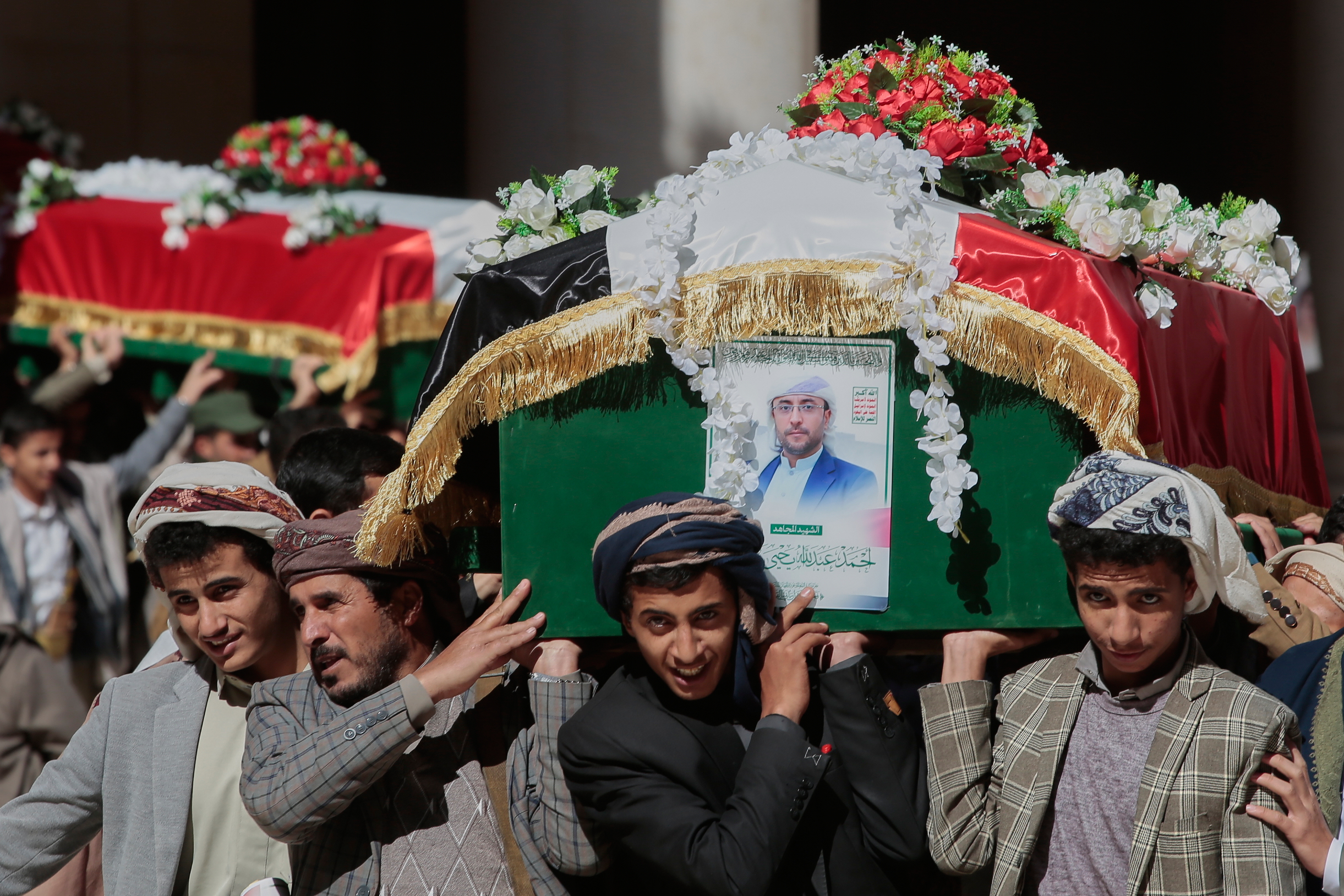 Houthi supporters carry the coffins of 5 leaders, who they said were killed during previous Israeli airstrikes, during a funeral at the people's mosque in Sanaa, Yemen, Thursday, Dec. 25, 2025. (AP Photo/Osamah Abdulrahman)