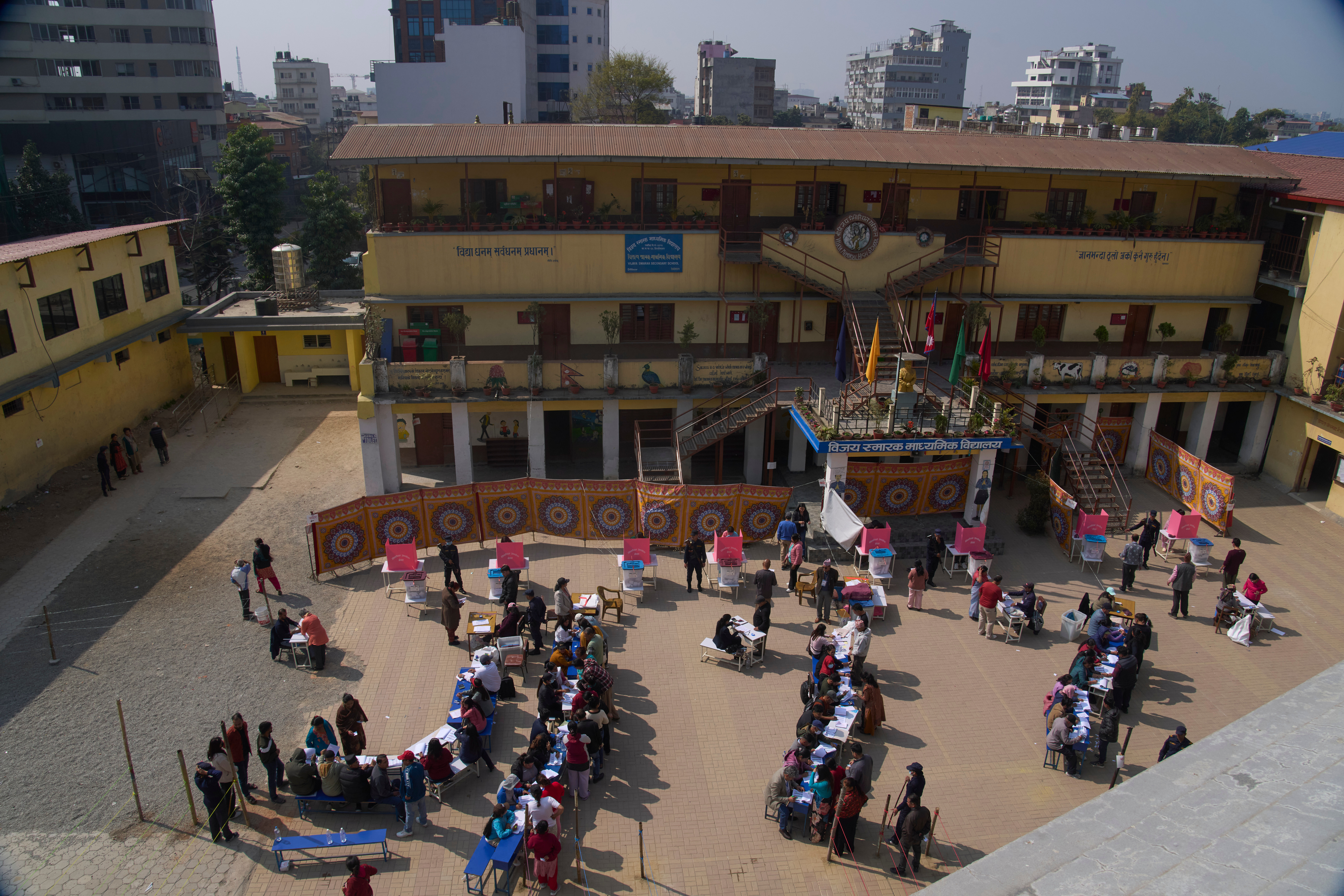 Nepalese people stand in a queue to cast their vote at a polling station for the parliamentary election in Kathmandu, Nepal, Thursday, March 5, 2026. (AP Photo/Niranjan Shrestha)