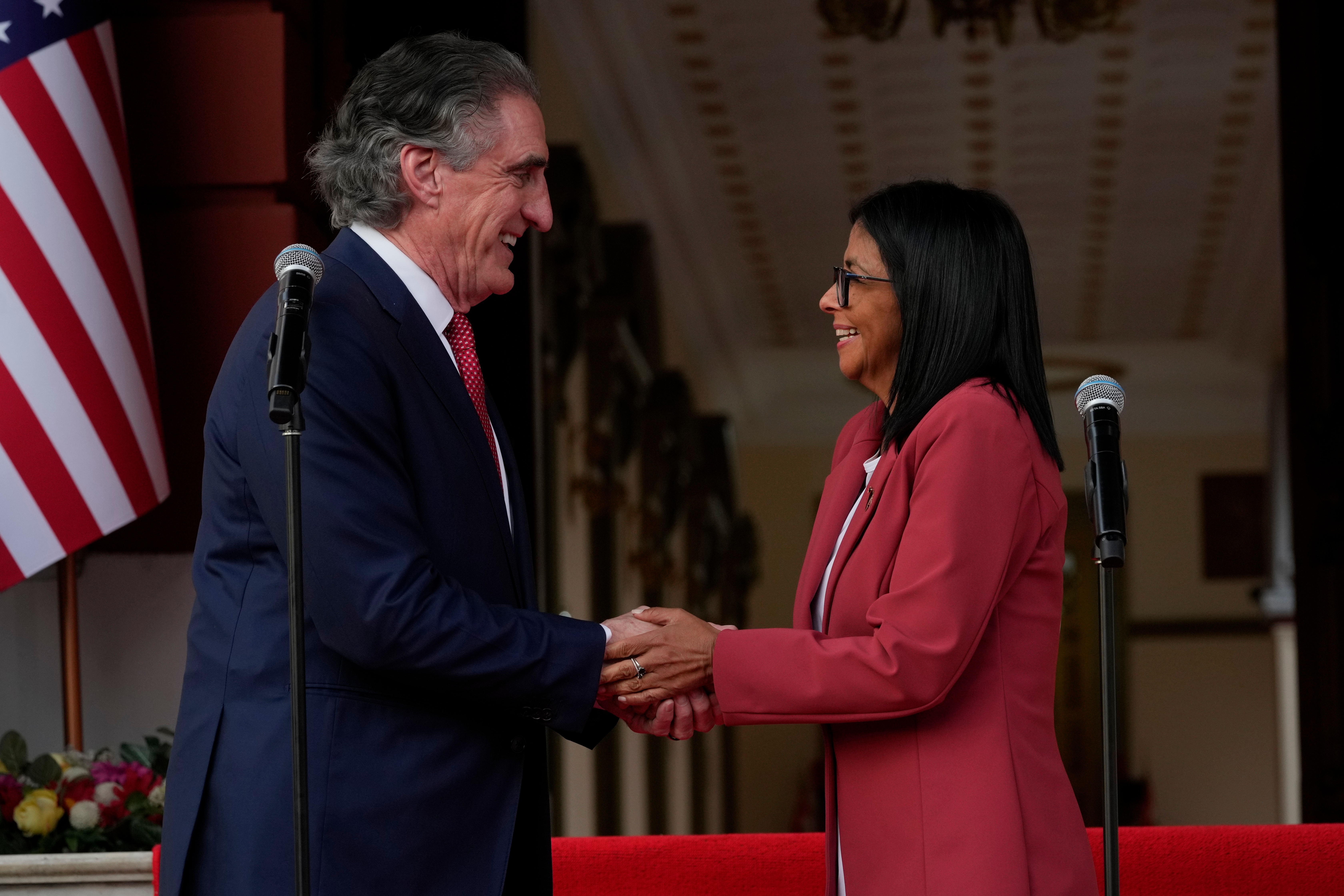 Venezuela's acting President Delcy Rodriguez, right, and U.S. Interior Secretary Doug Burgum shake hands after a meeting at Miraflores presidential palace in Caracas, Venezuela, Wednesday, March 4, 2026. (AP Photo/Ariana Cubillos)