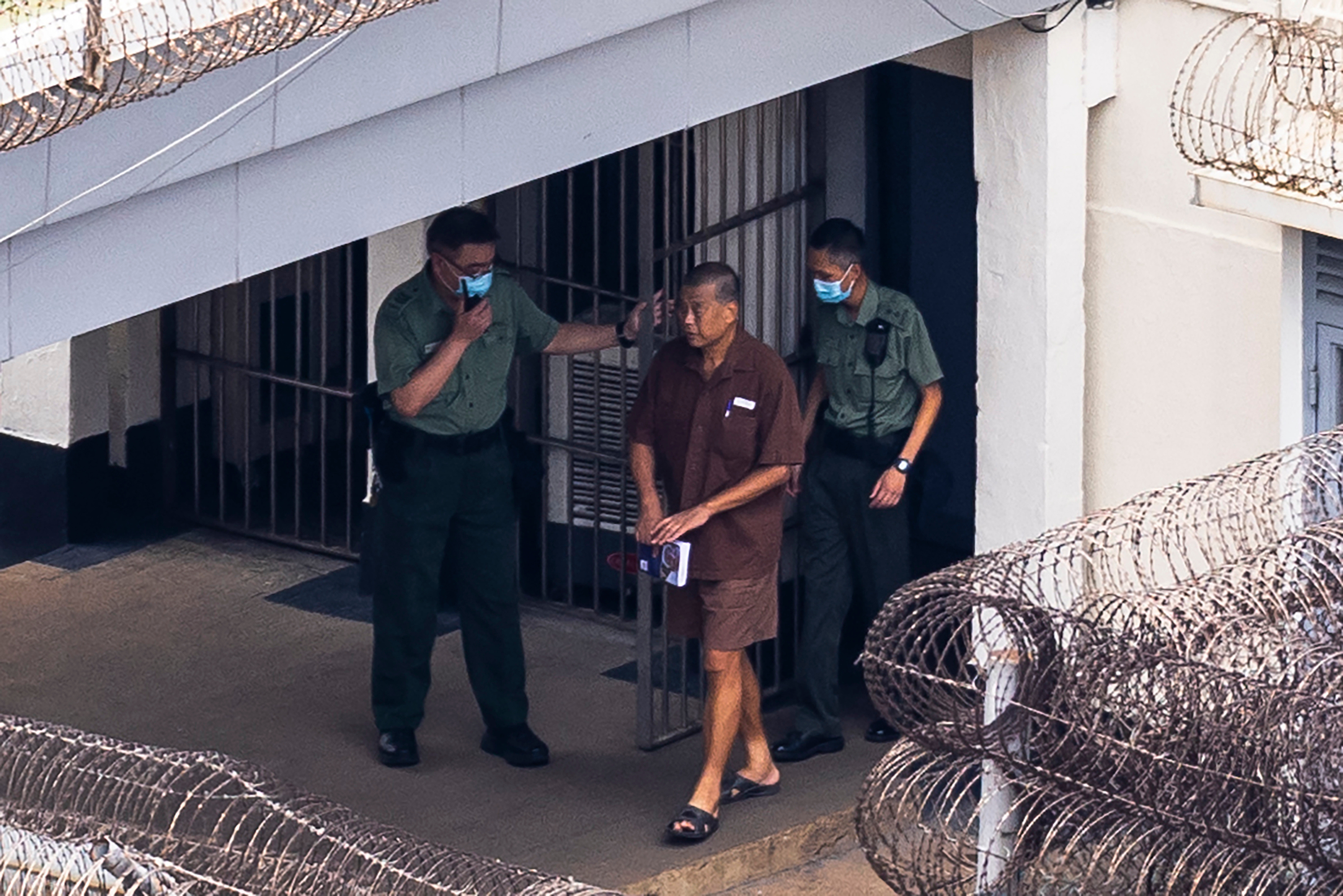 FILE - Jimmy Lai walks through the Stanley prison, in Hong Kong, July 28, 2023. (AP Photo/Louise Delmotte, File)